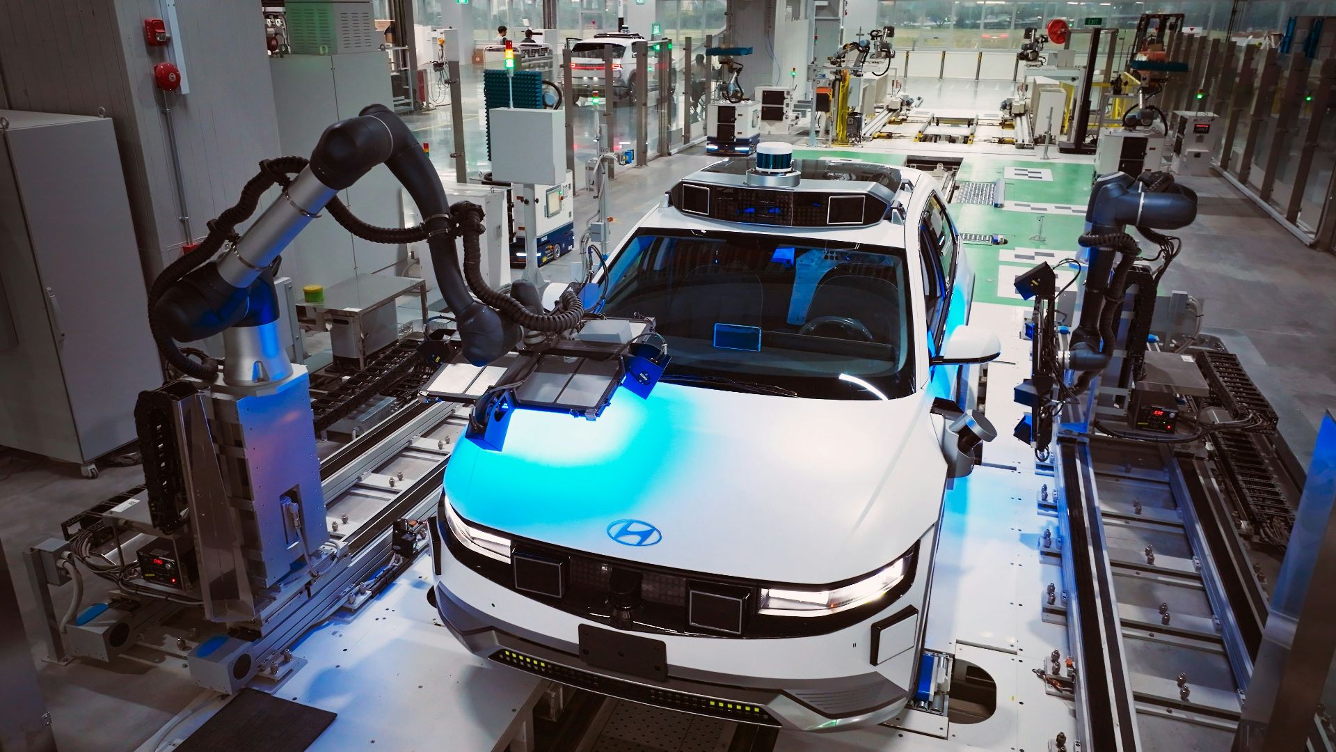 a white car is on a assembly line