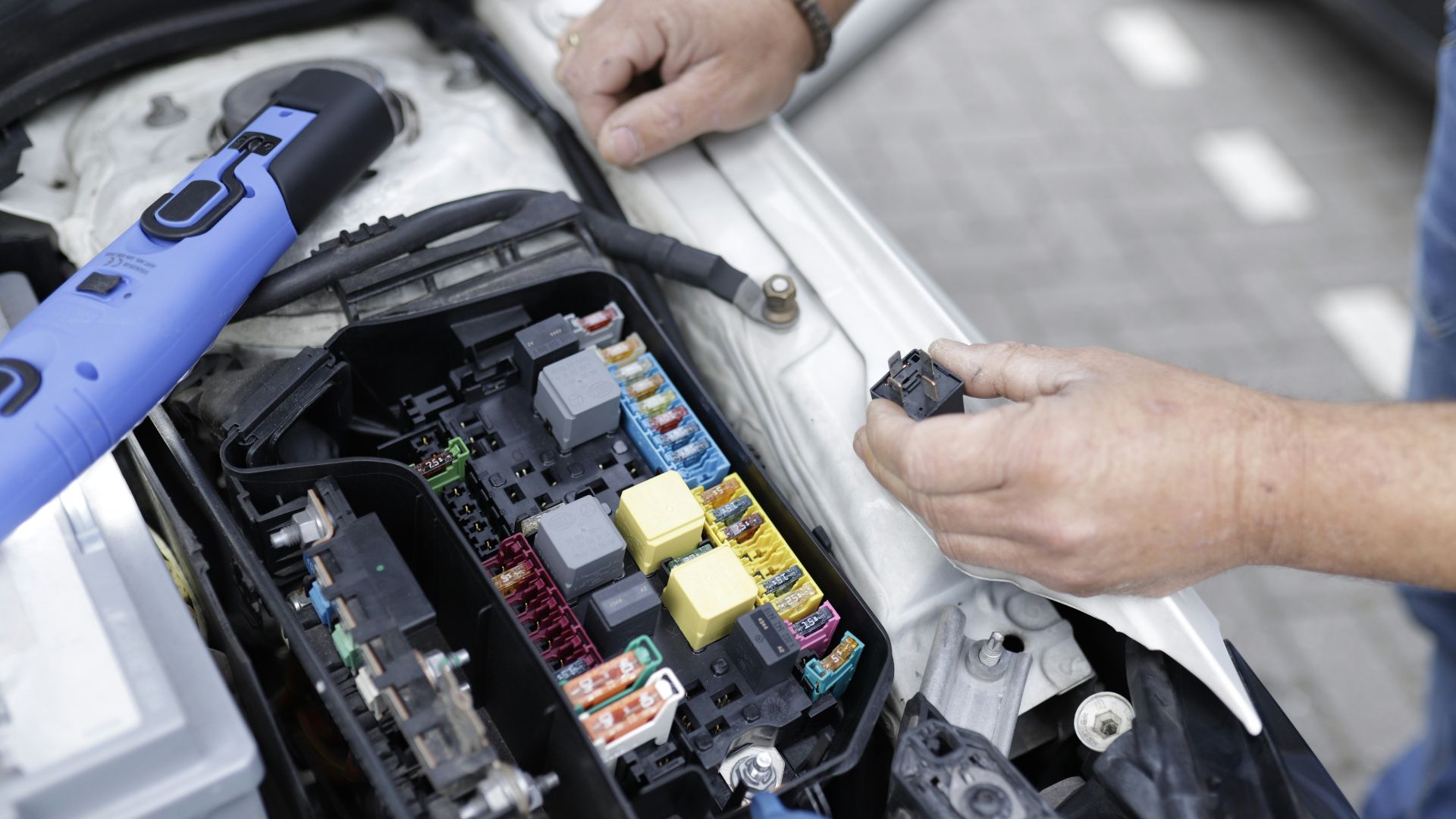 a man is working on a car's engine