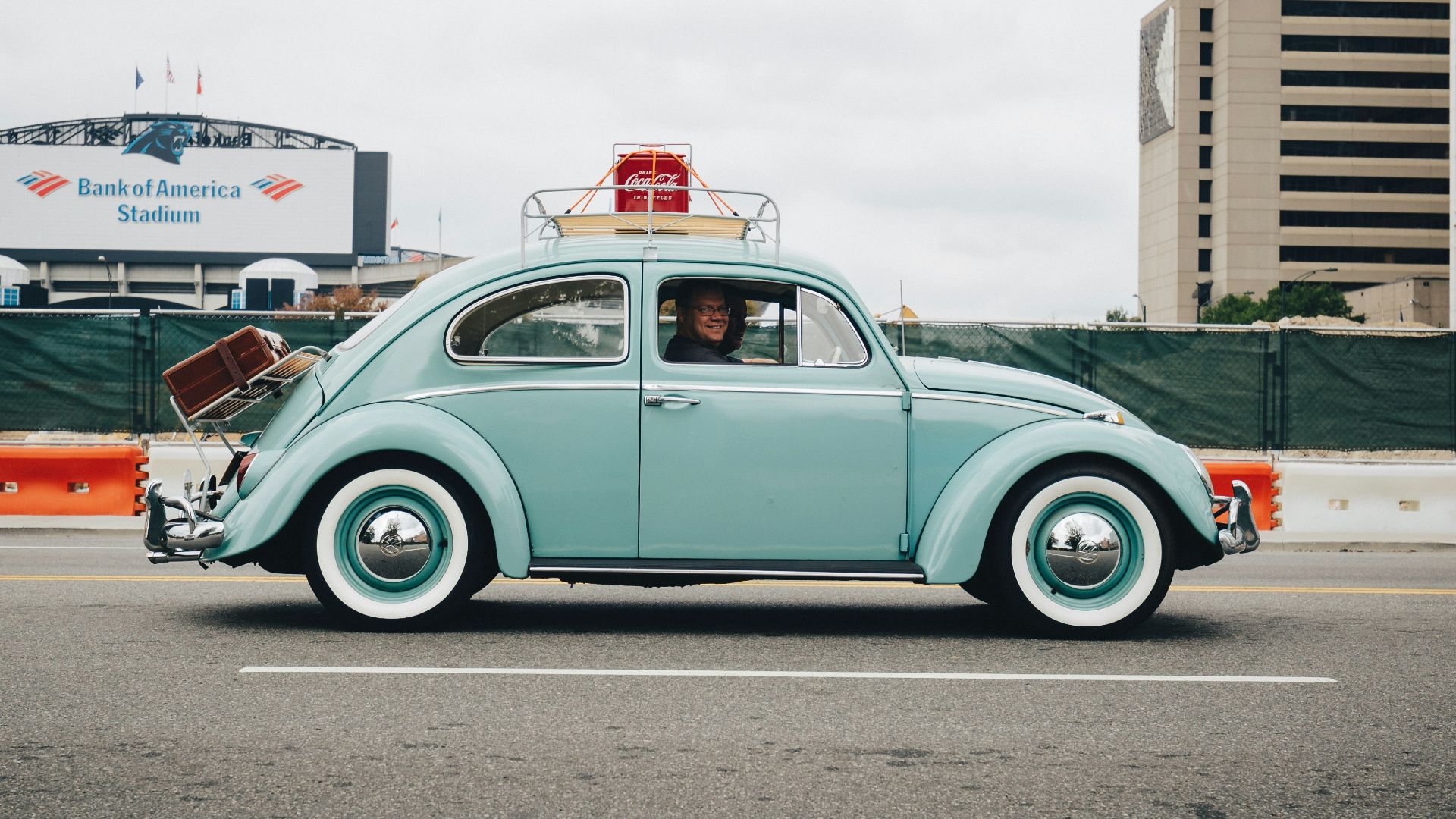 teal Volkswagen Beetle car on road