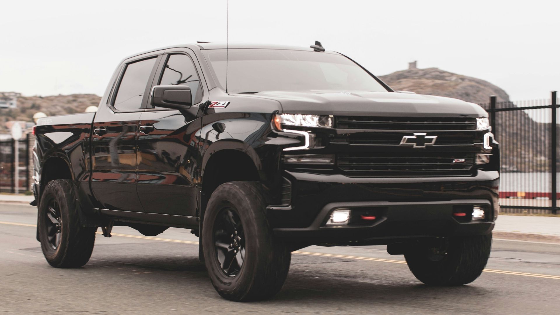 black chevrolet single cab pickup truck on gray sand during daytime