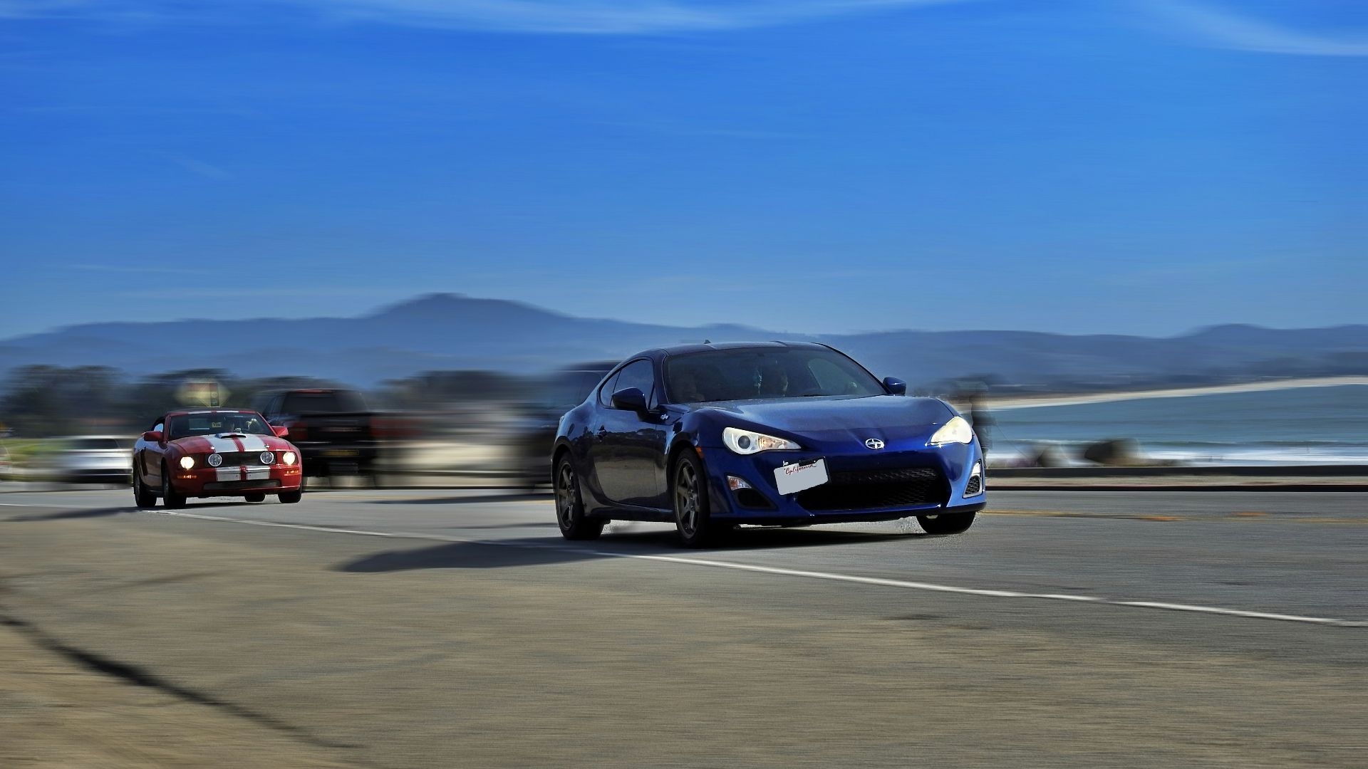 black sedan on gray asphalt road during daytime