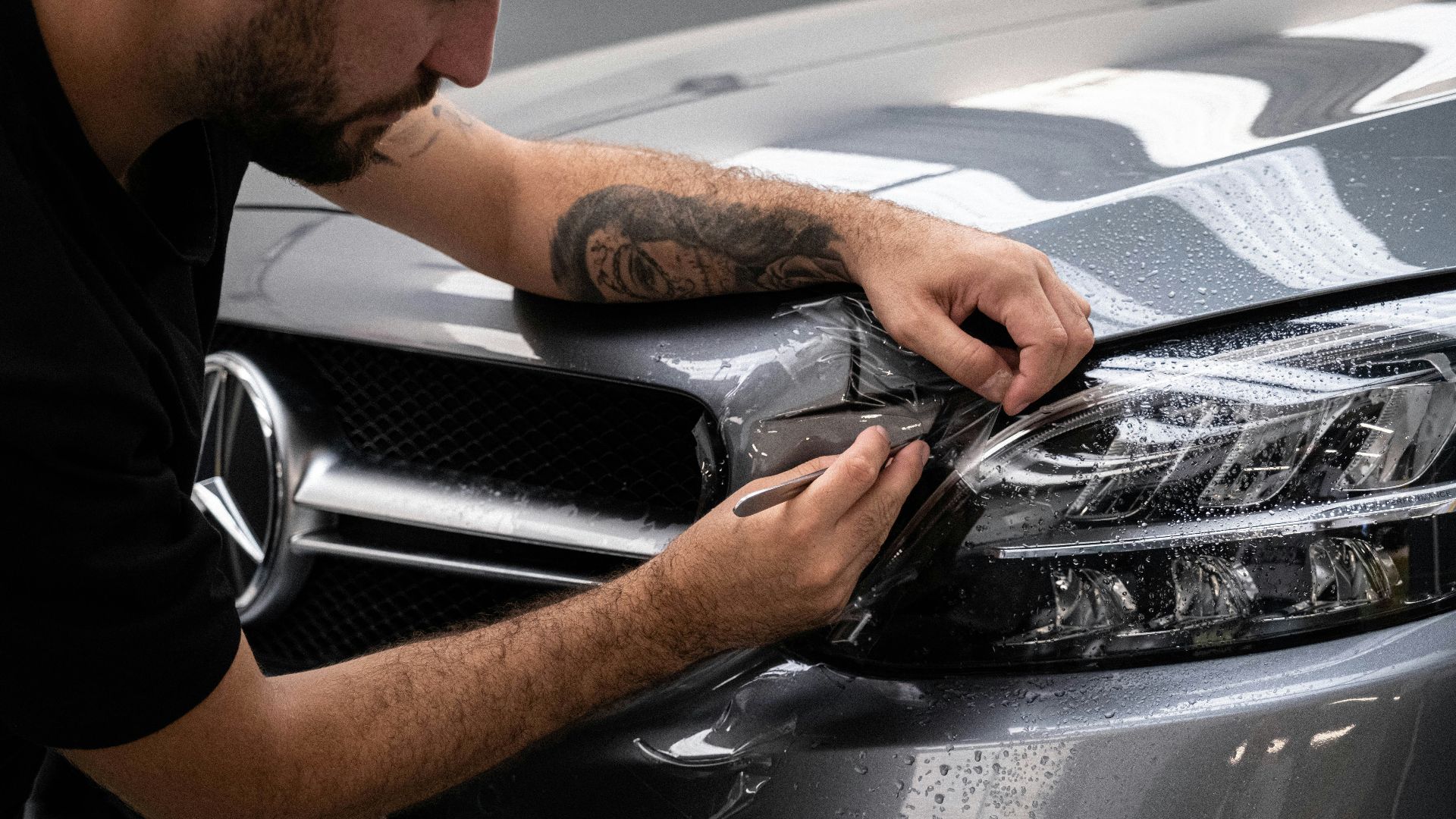 a man waxing the hood of a car