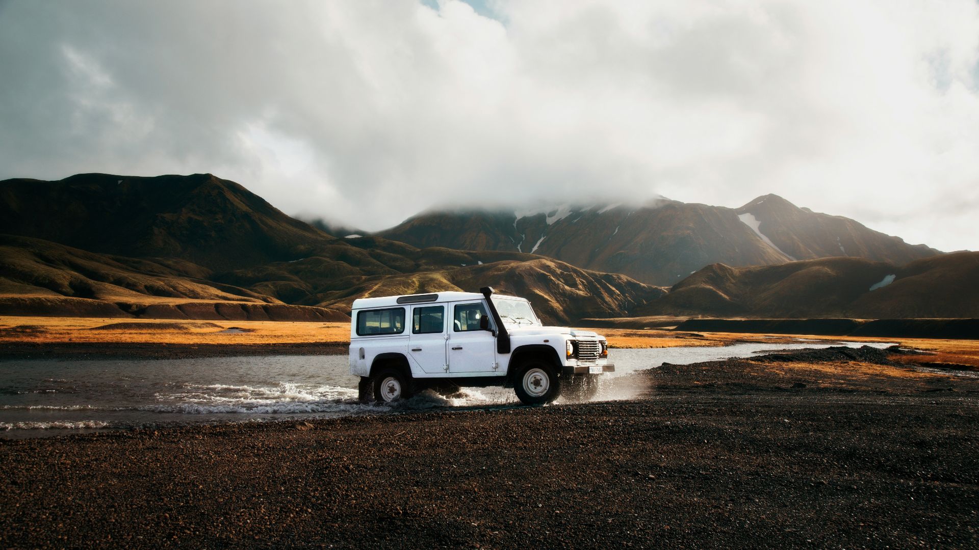 white car crossing body of water