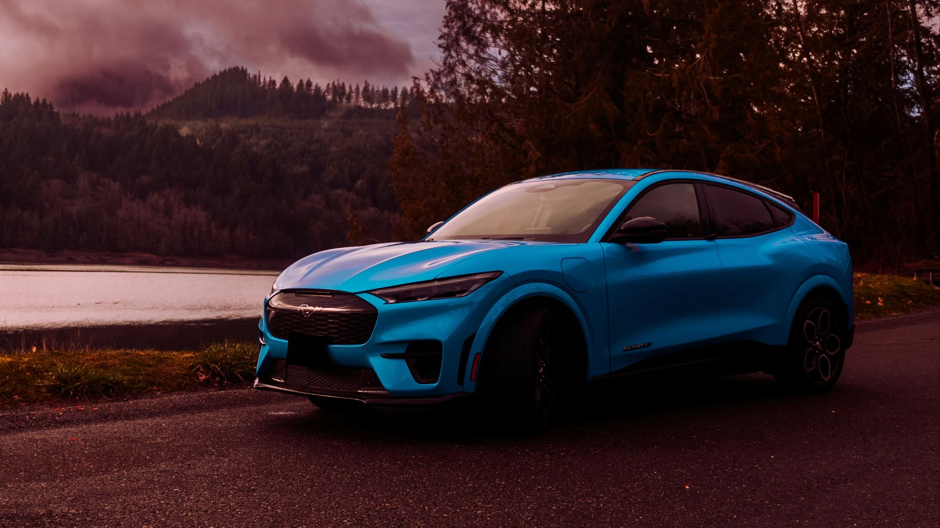a blue sports car parked on the side of a road