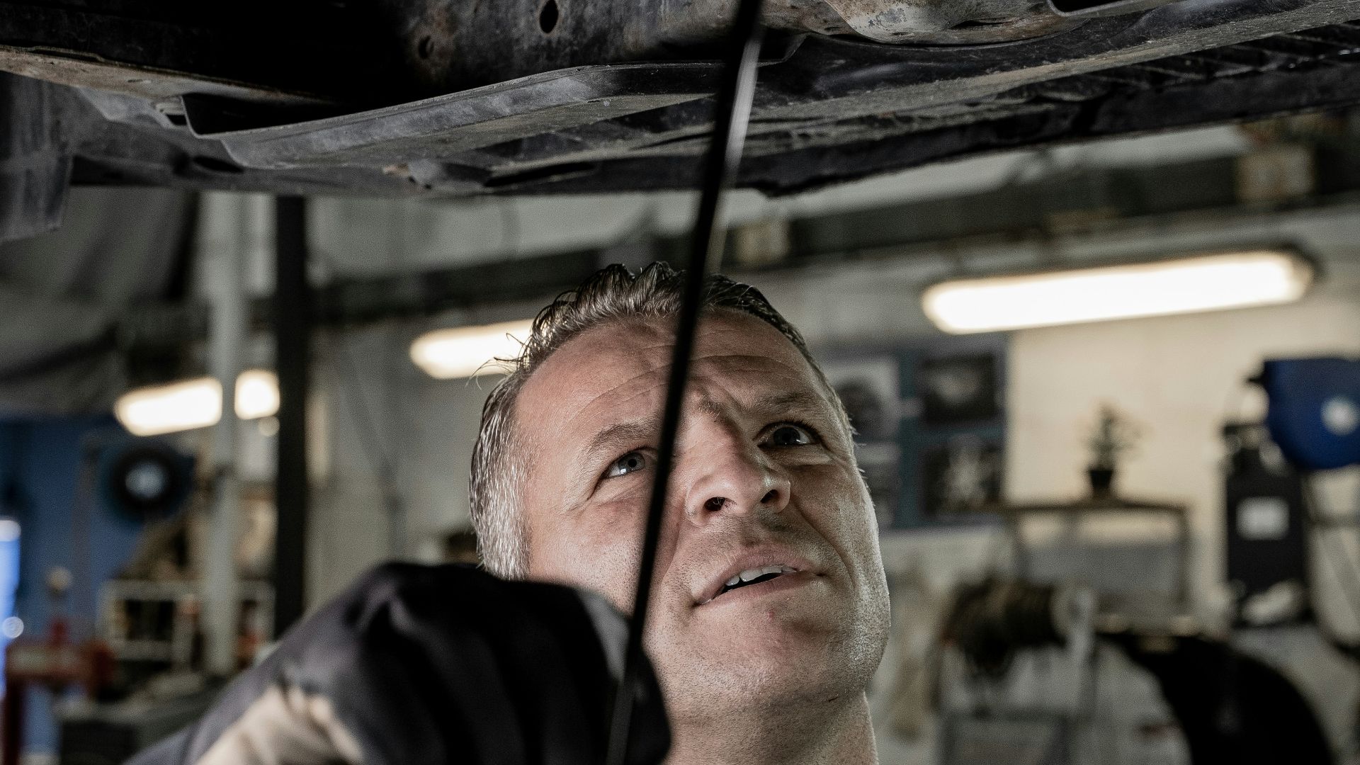 a man working on a car in a garage