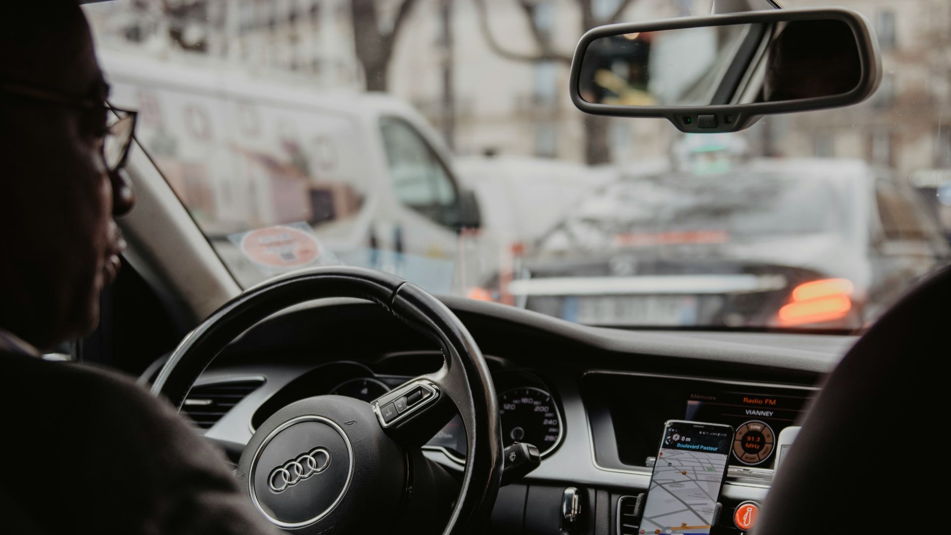 man in black jacket driving car during daytime