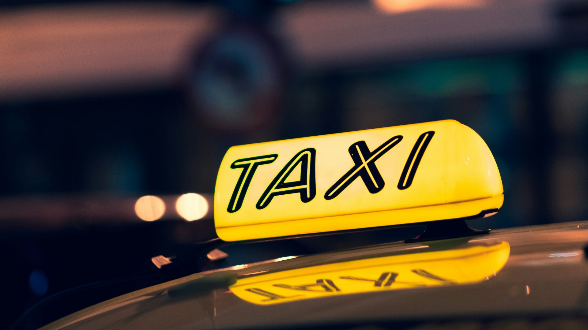 yellow taxi cab on road during night time