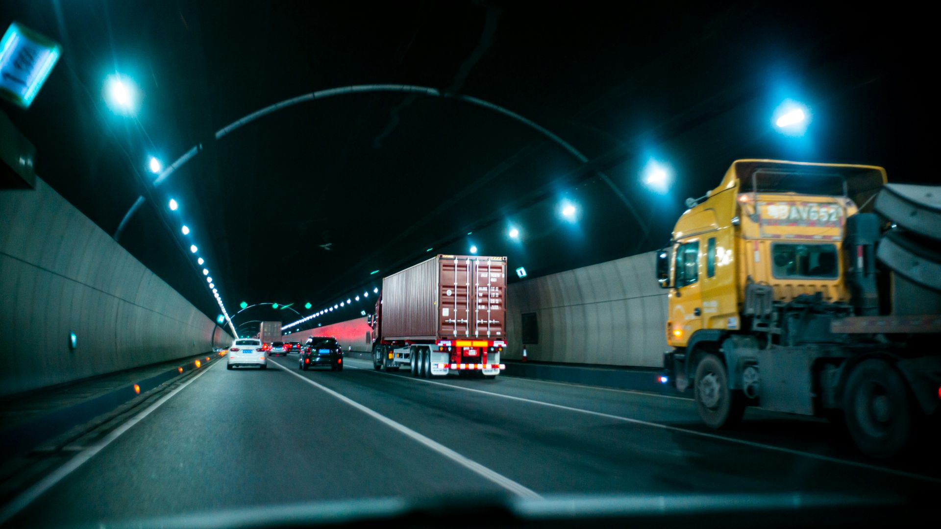 yellow truck on road during nighttime