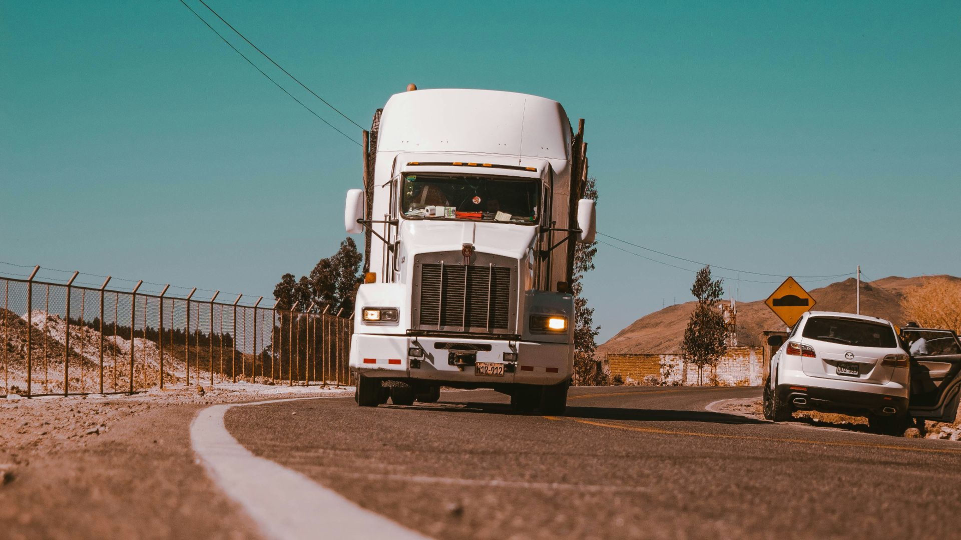 white freight truck on grey concrete road