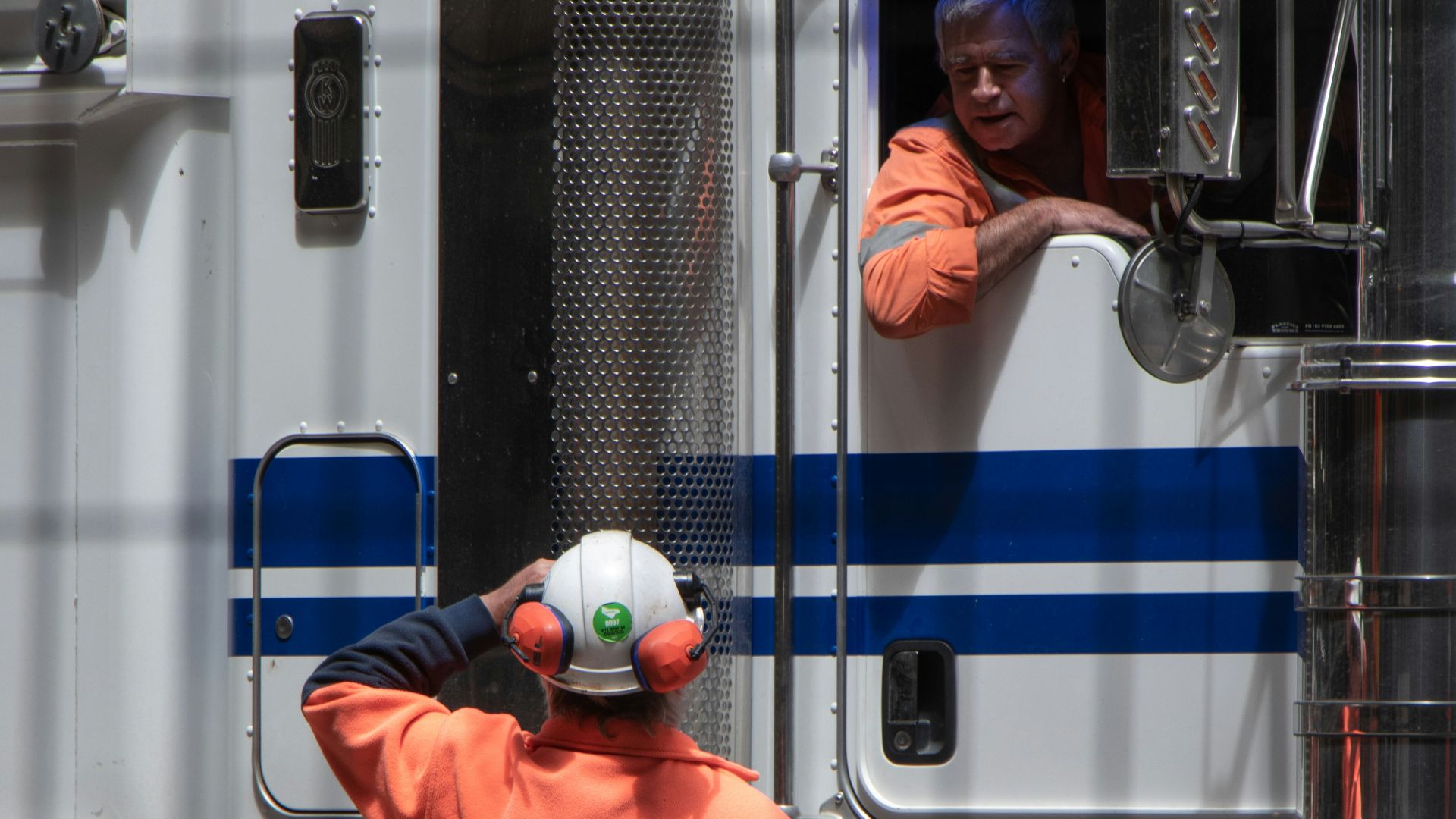 man standing in front of freight truck