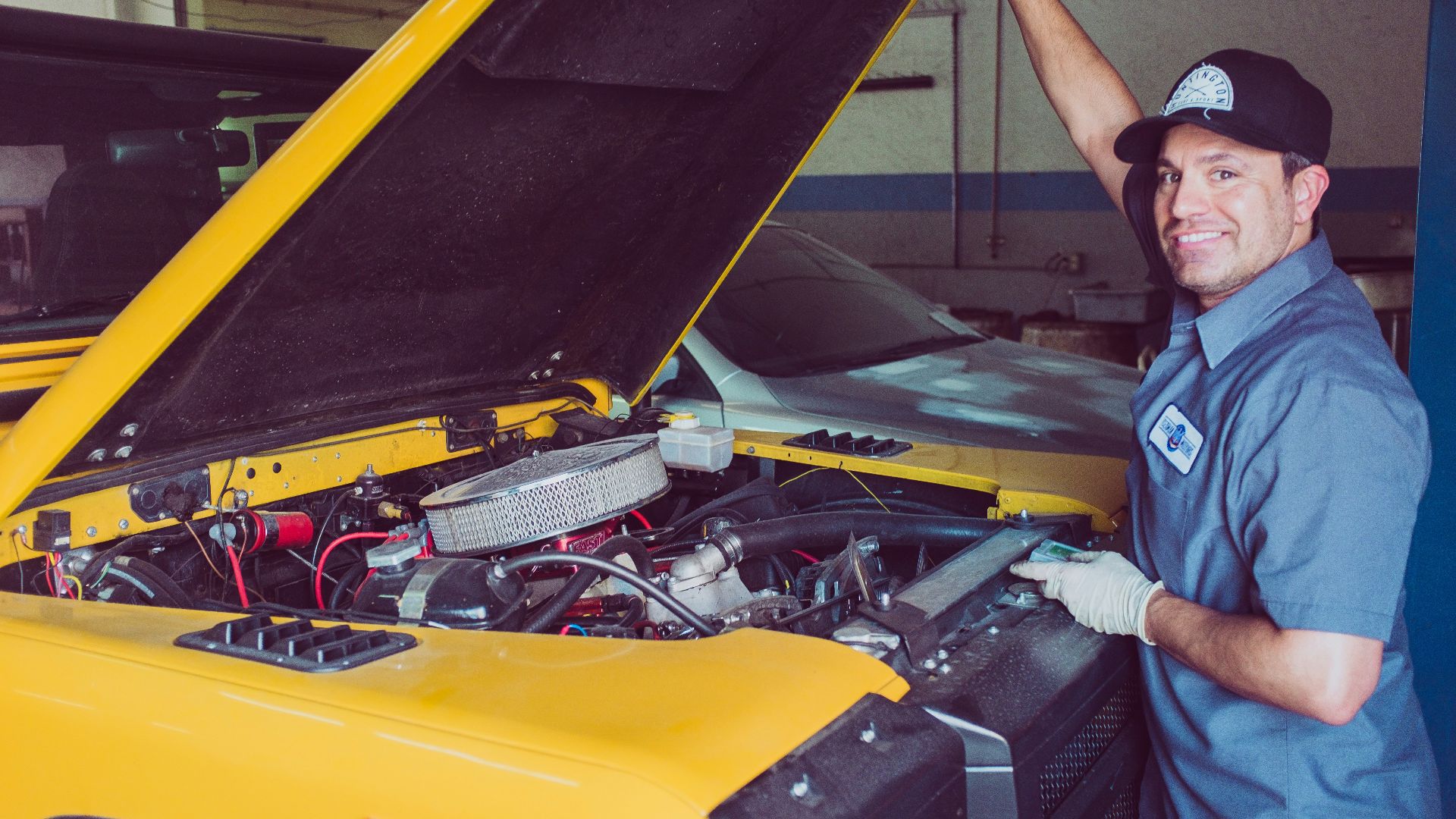 man holding open-wide car trunk