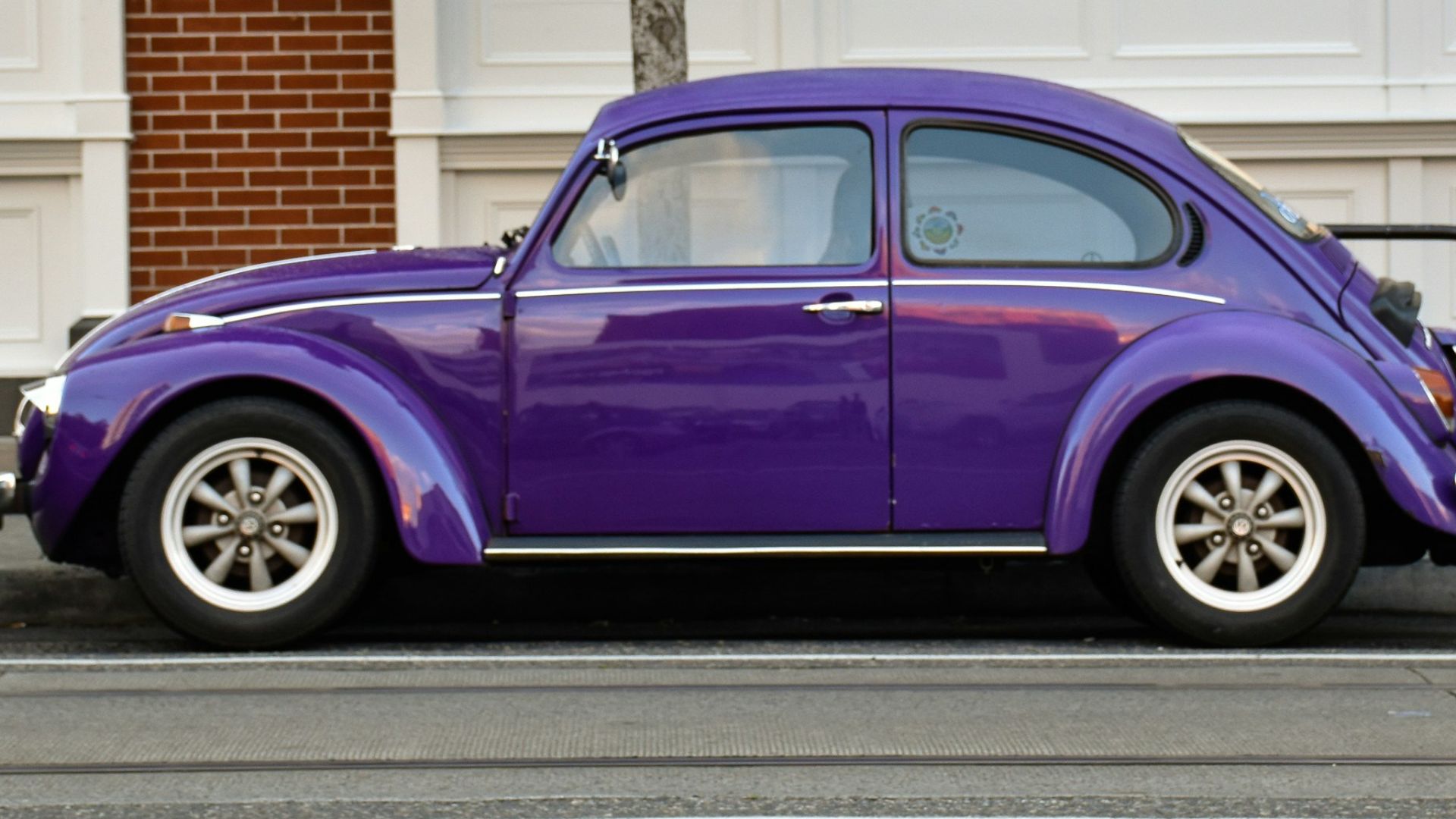 purple 3-door hatchback parked on street
