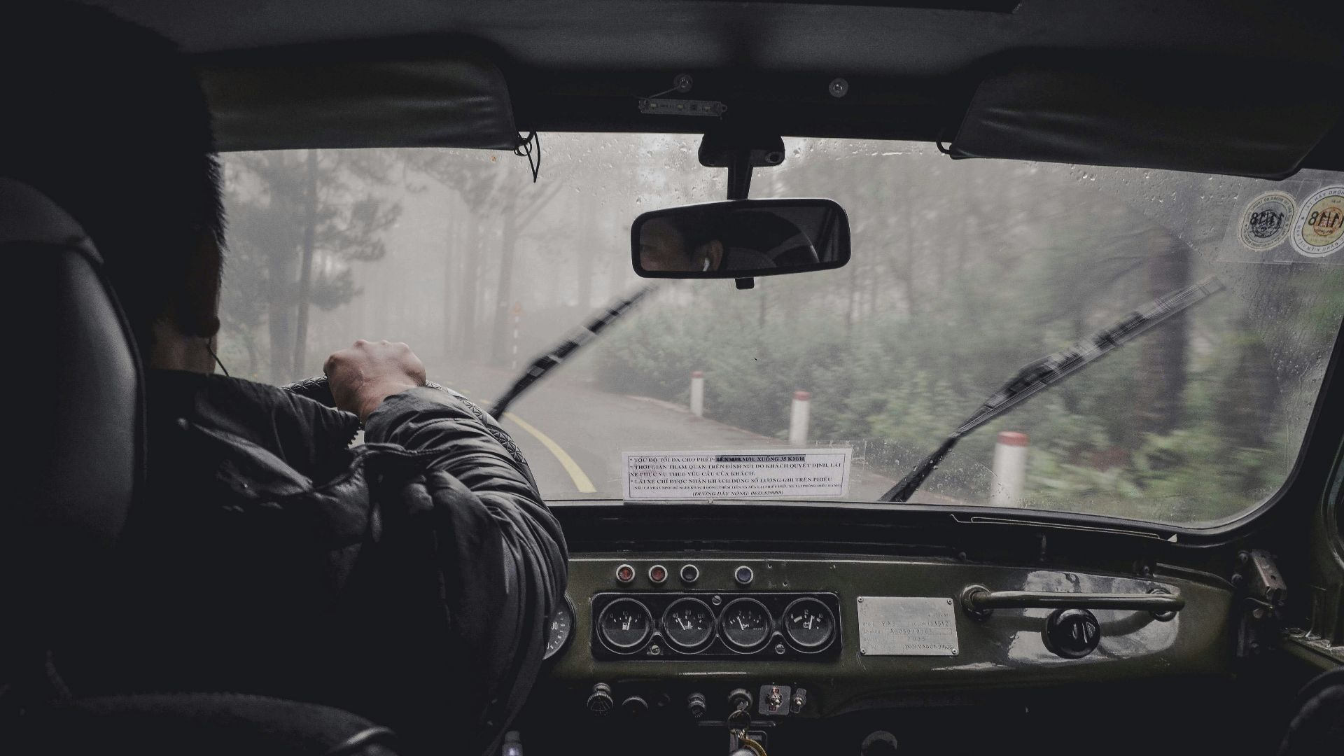 man driving car during rainy daytime