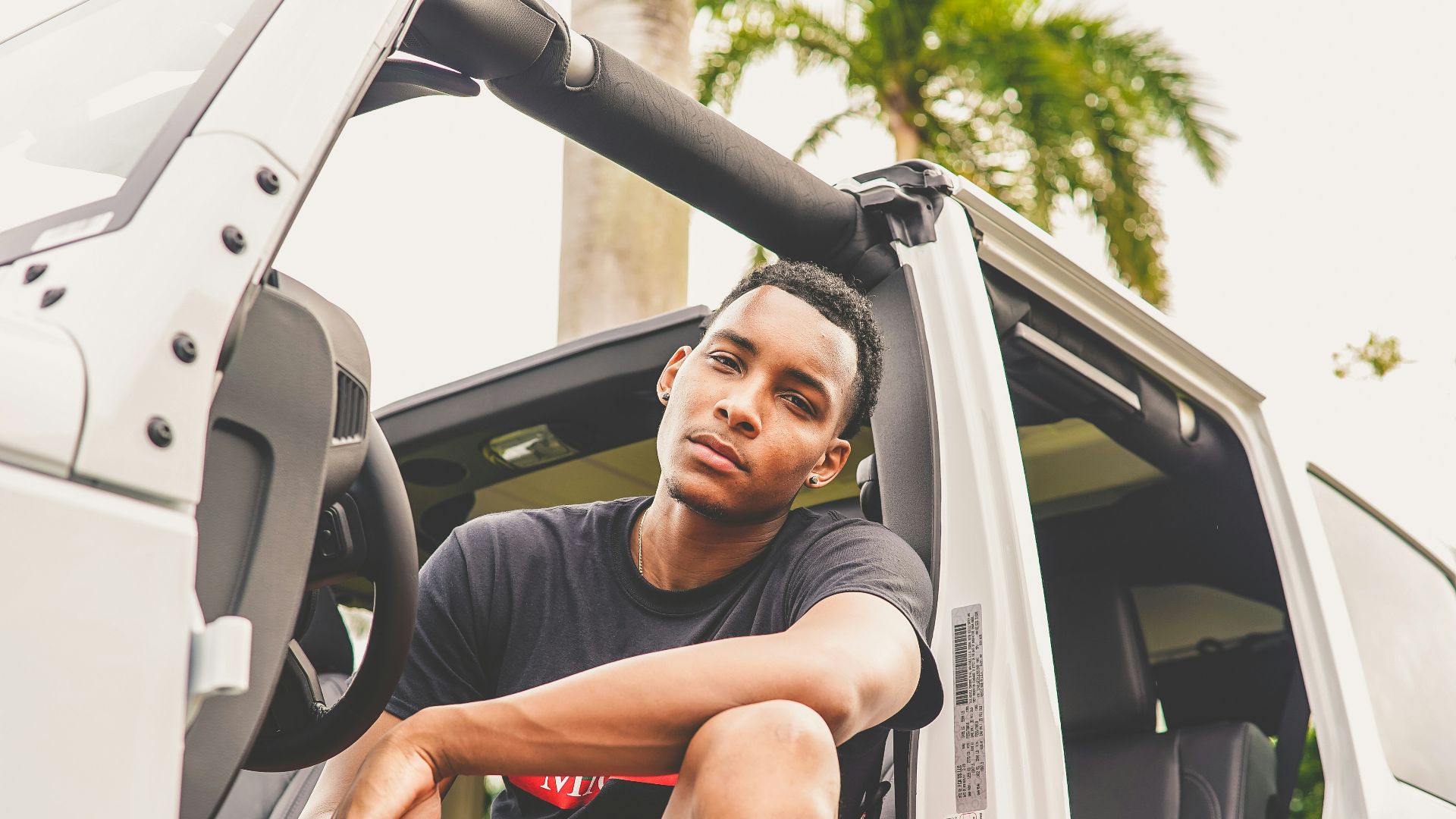 man sitting on vehicle