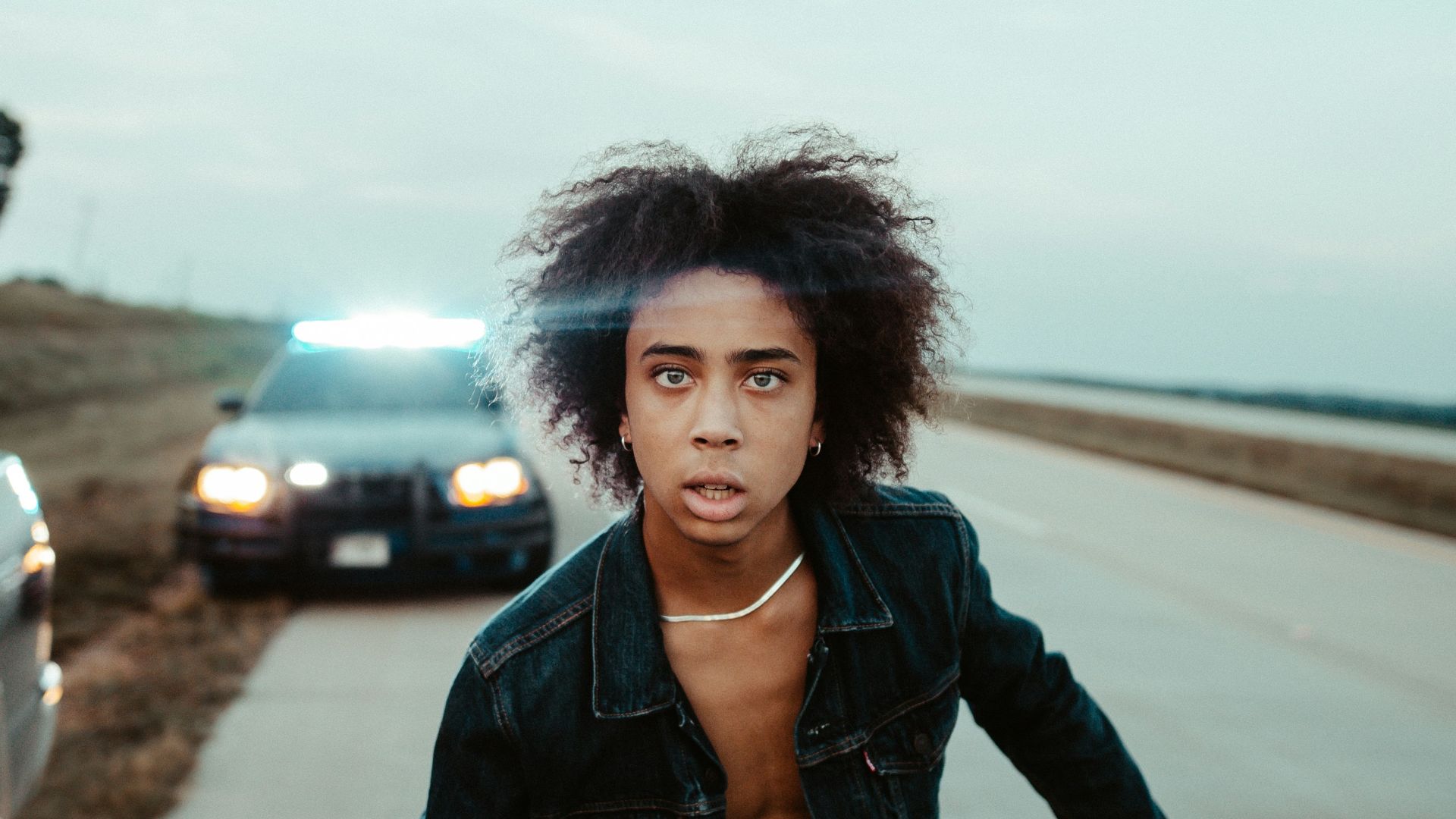 man standing in the middle of highway