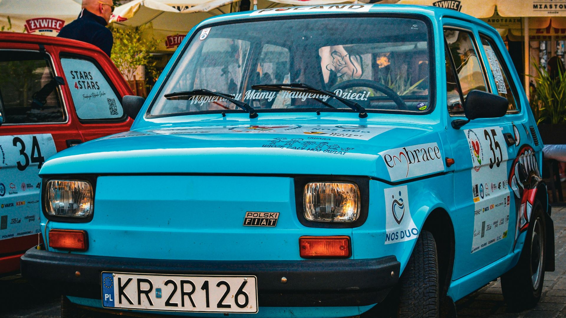 A blue car parked in front of a building