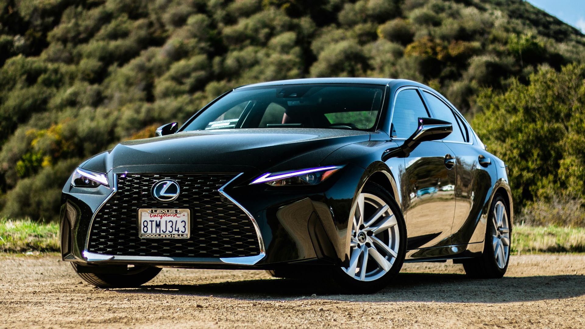 black porsche 911 on brown field during daytime