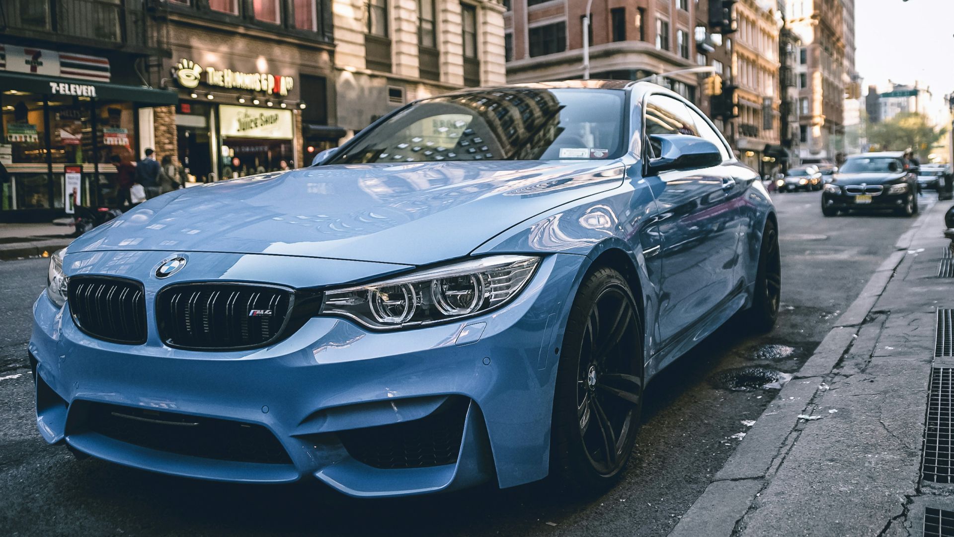 blue BMW coupe parked on the road during daytime