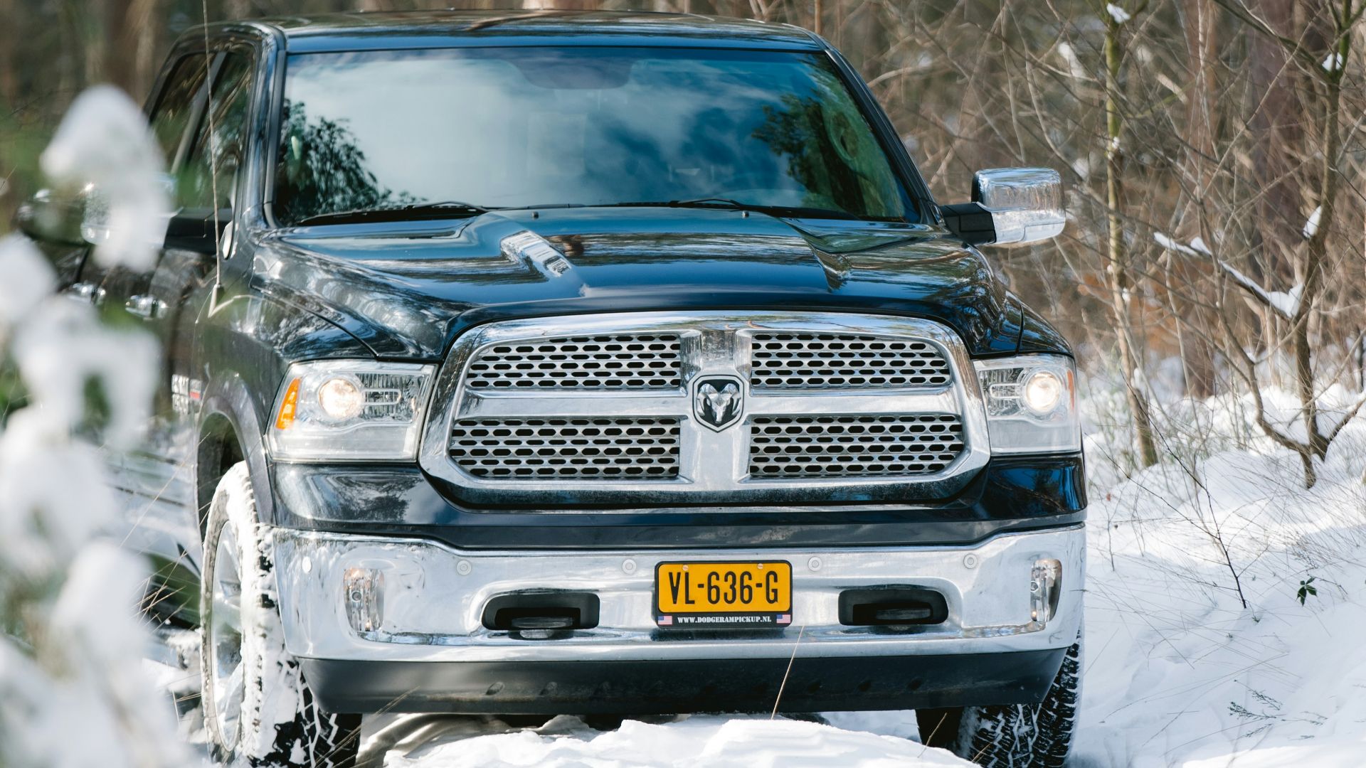 black chevrolet car on snow covered ground during daytime