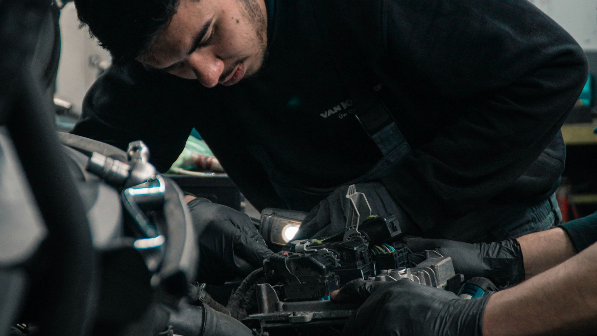 man in black jacket and blue denim jeans riding motorcycle