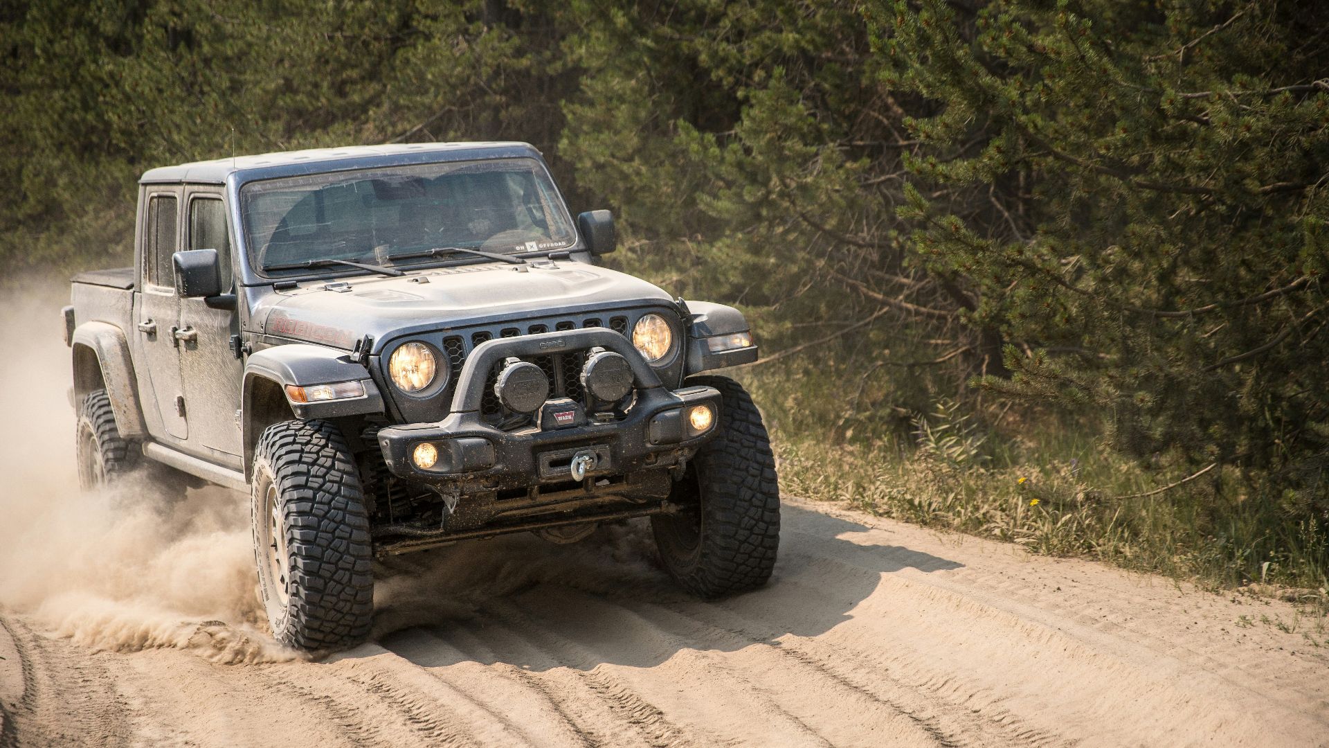 black and white jeep wrangler on dirt road during daytime