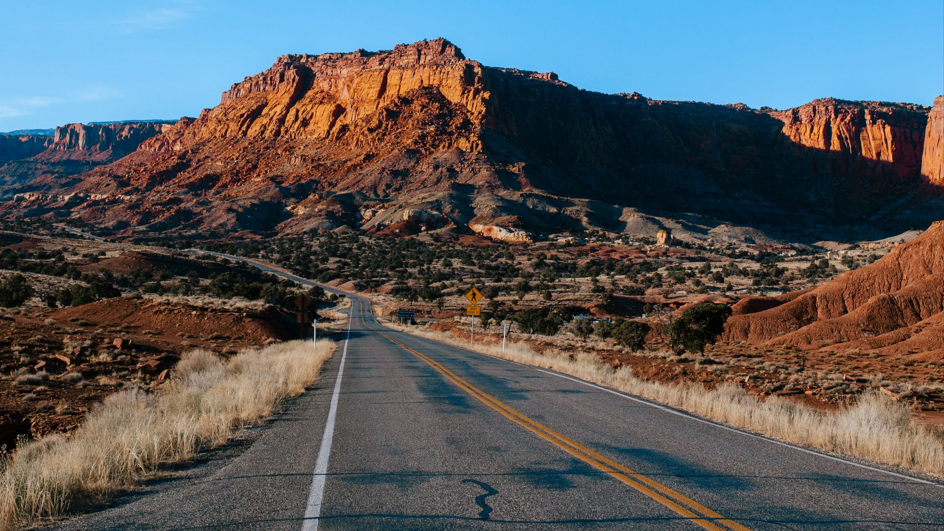 a road with a mountain in the background