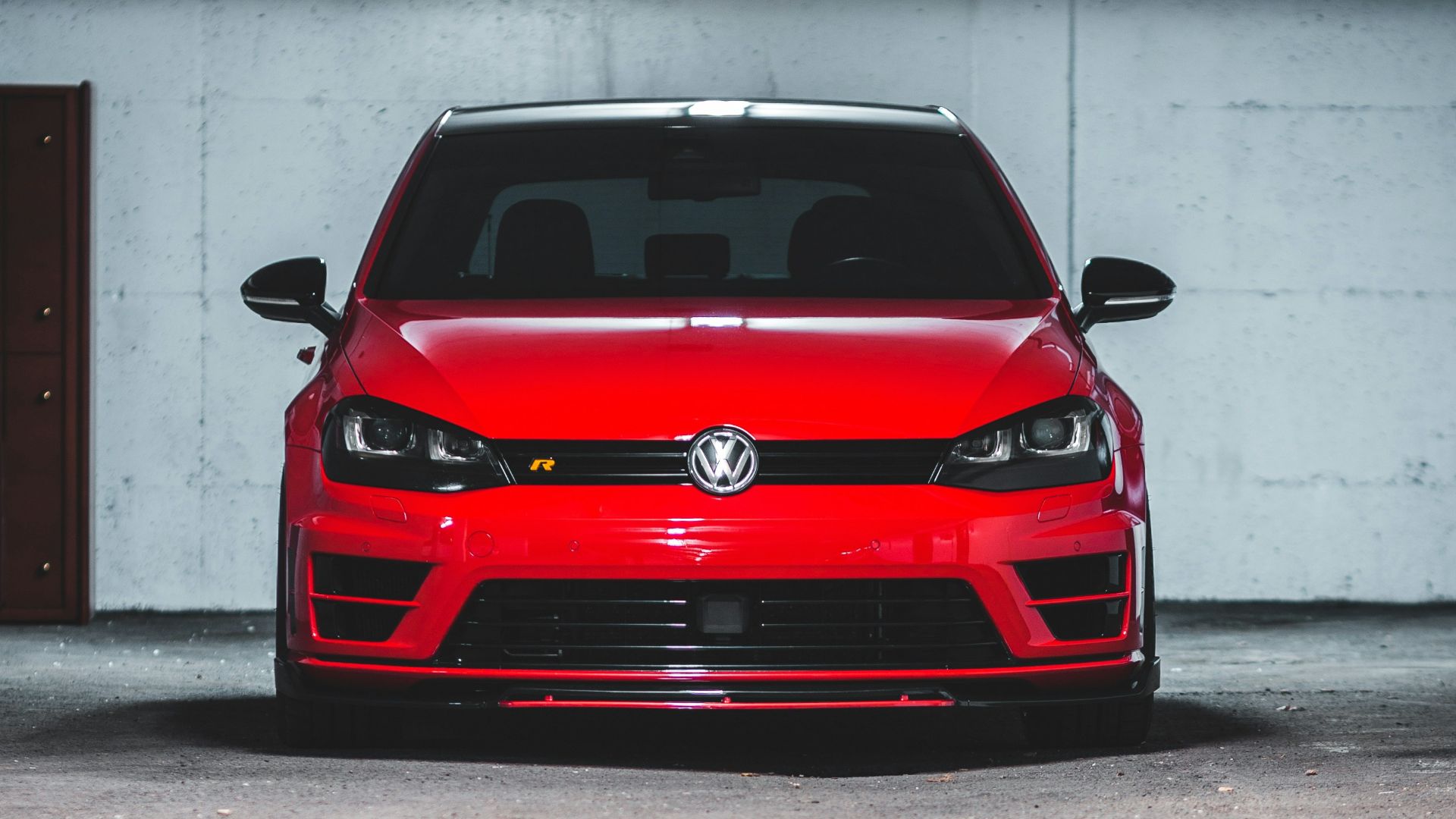 a red car parked in a parking garage