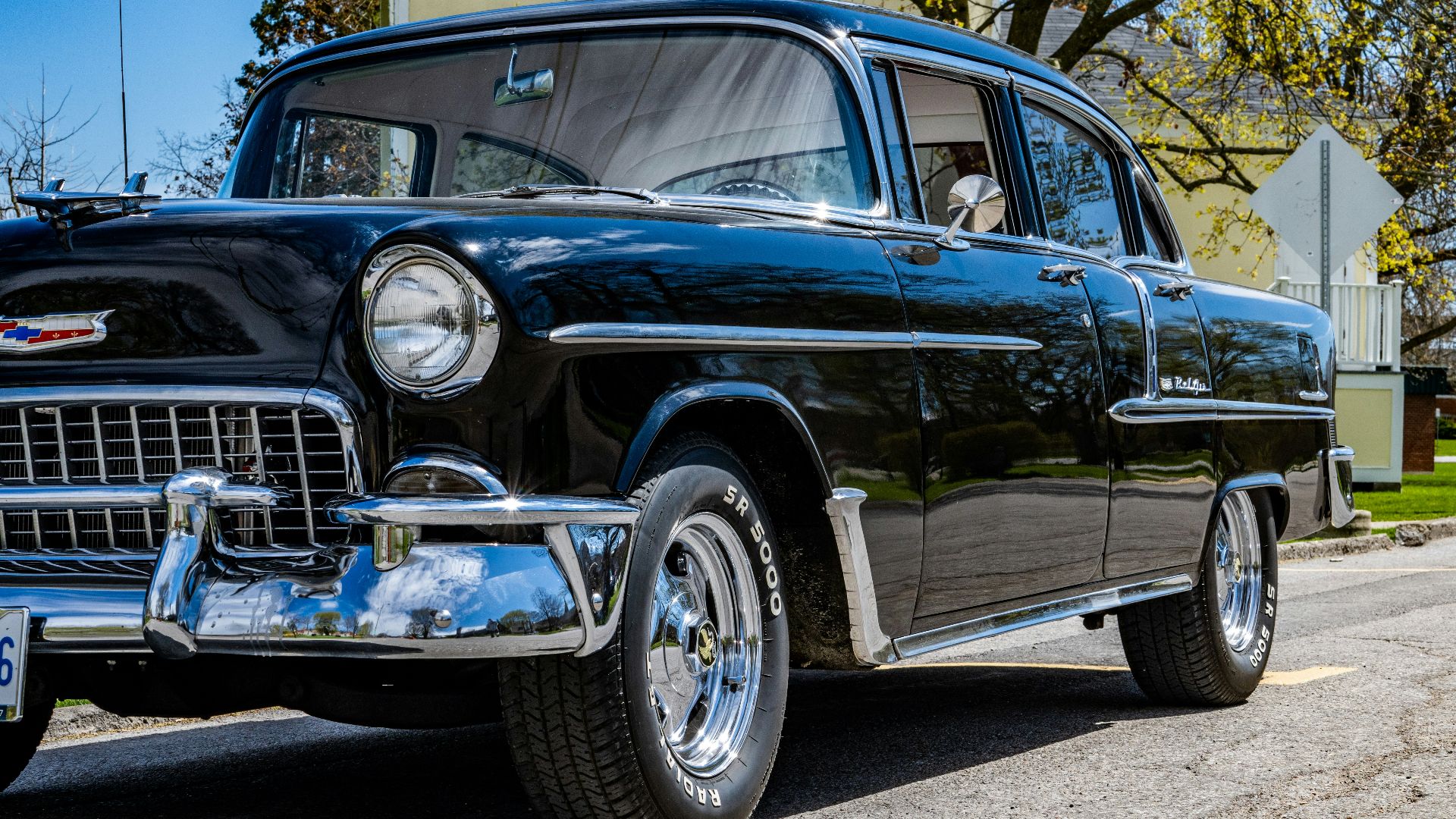 black classic car on gray concrete pavement