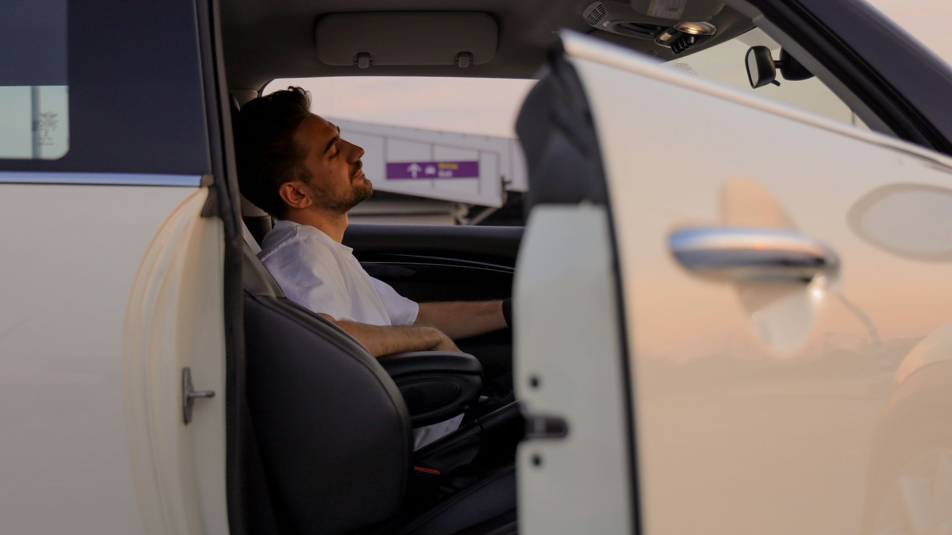 a man sitting in the driver's seat of a car