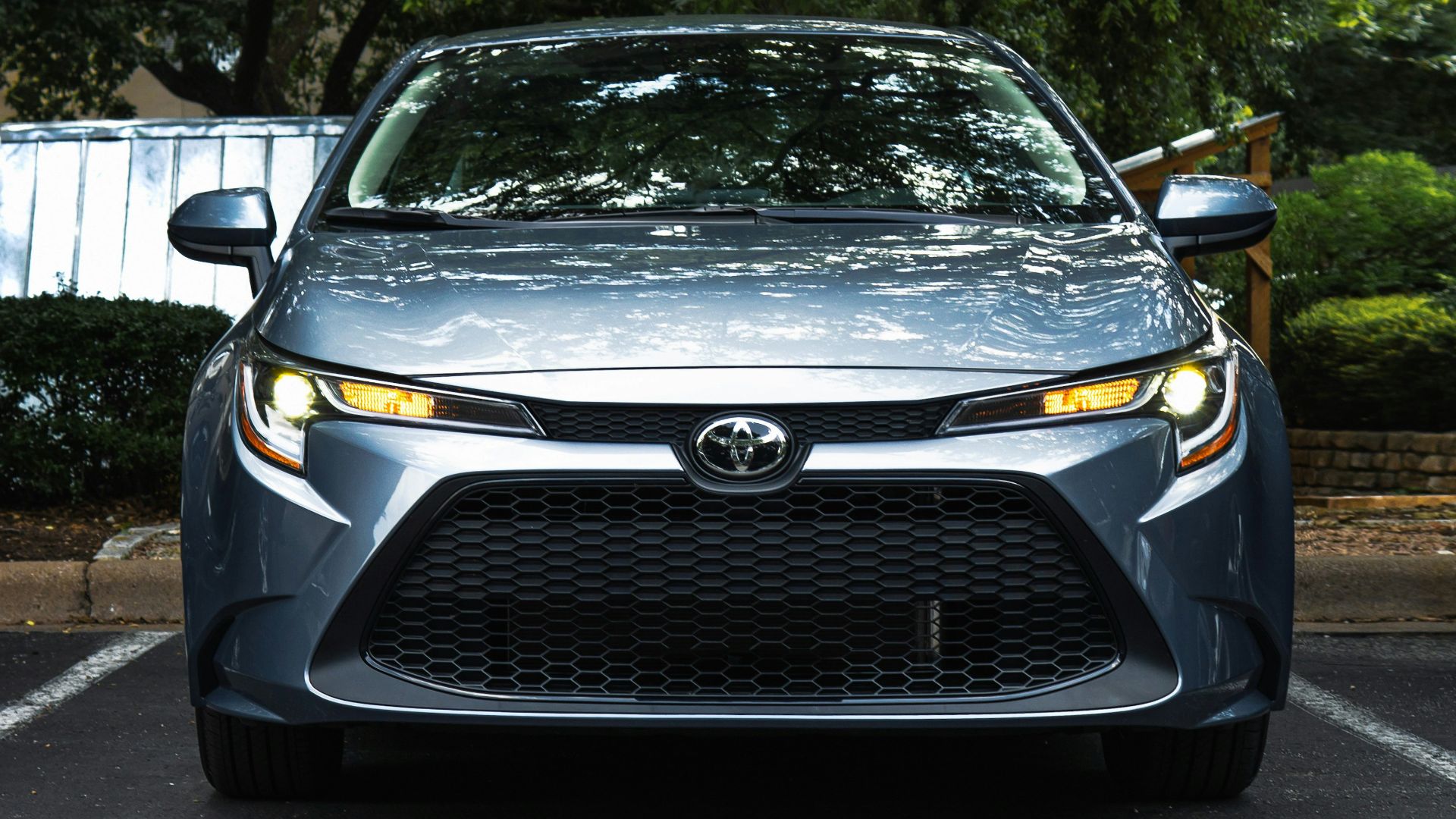 black mercedes benz car parked near green trees during daytime