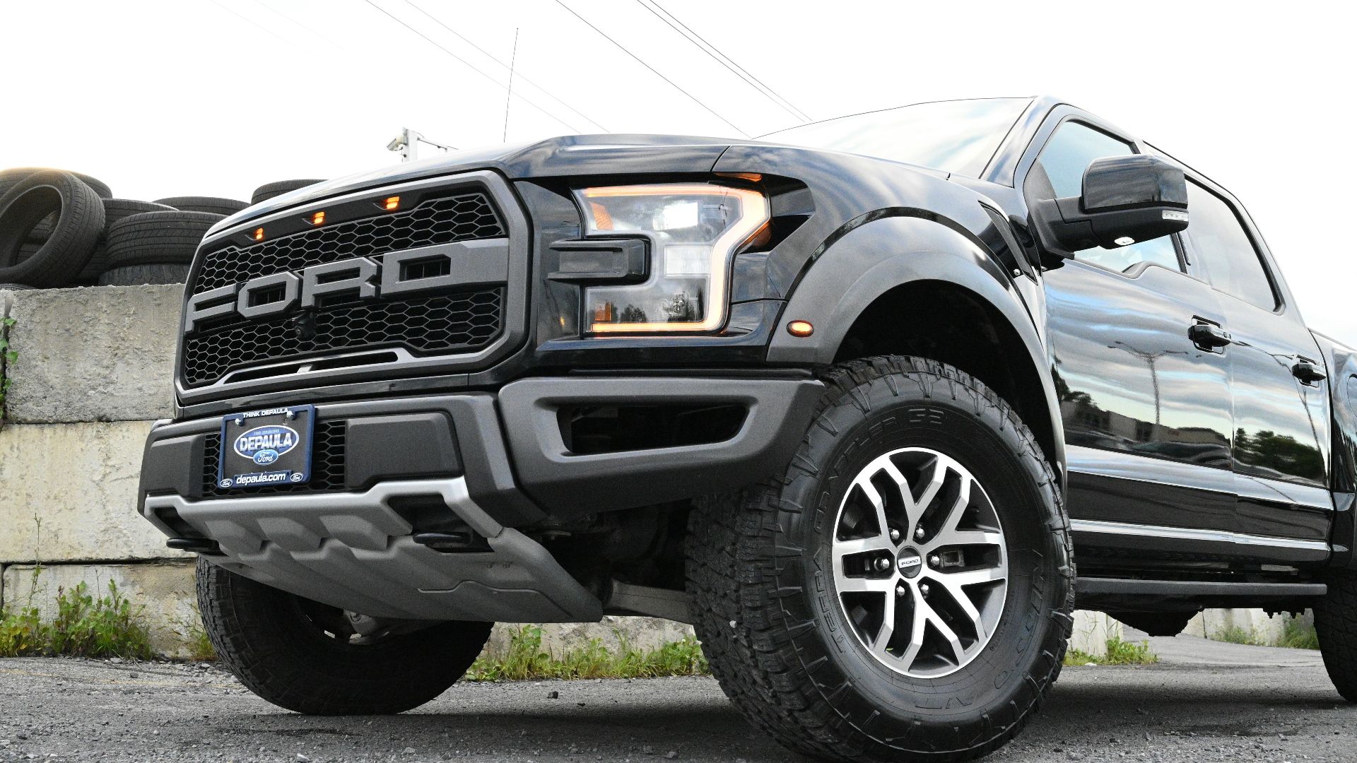 a large black truck parked in a parking lot