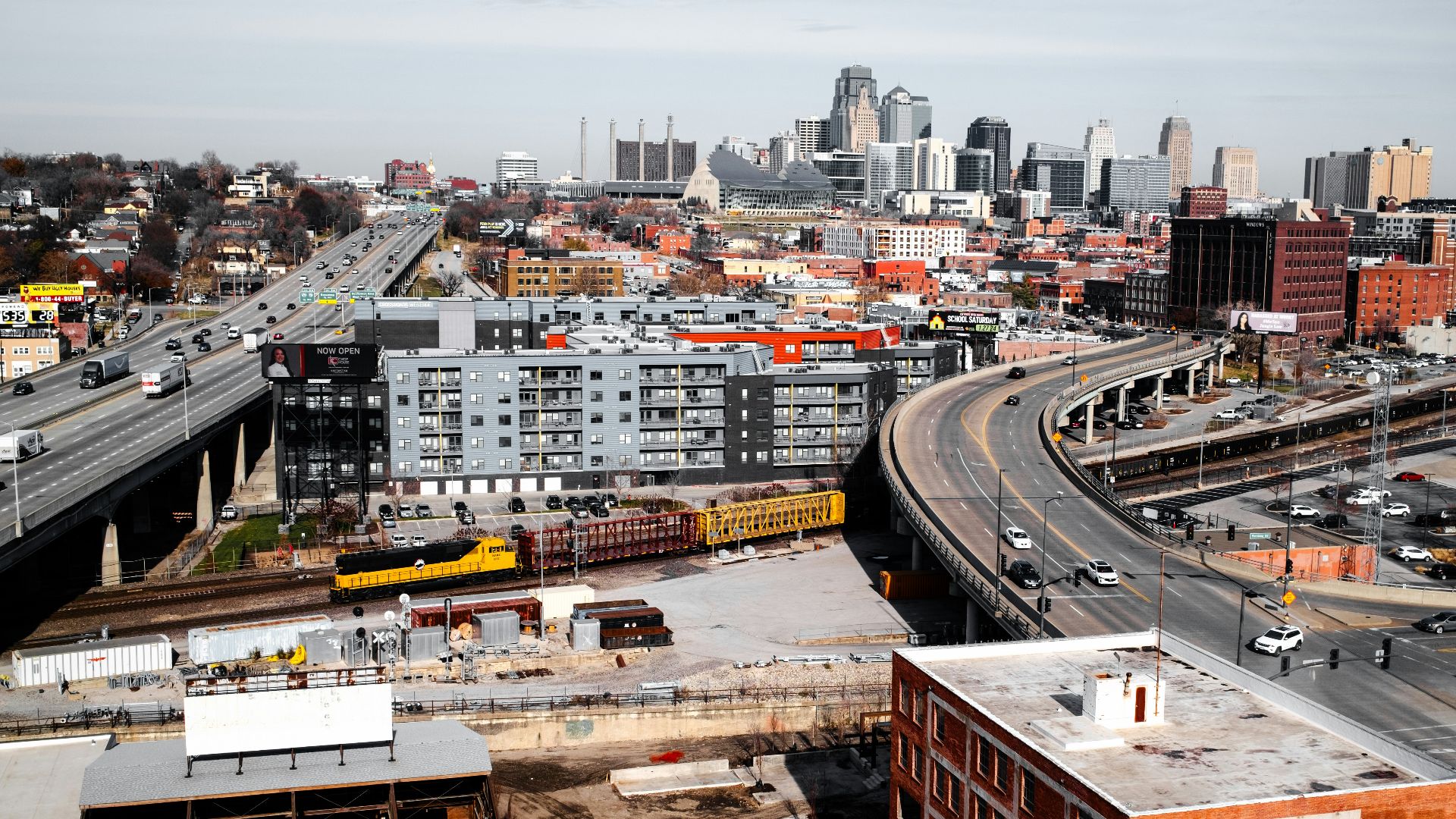 an aerial view of a city with a train on the tracks