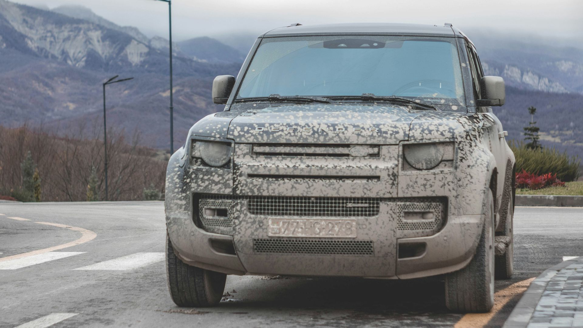 a silver truck parked on the side of a road