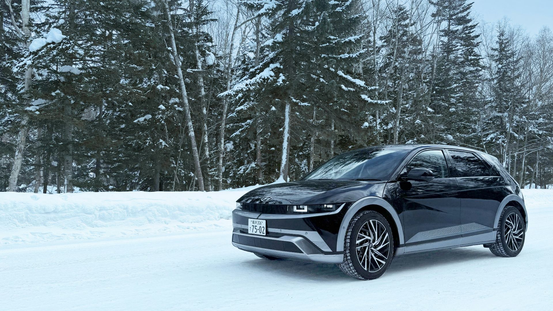 Black suv on a snowy road.