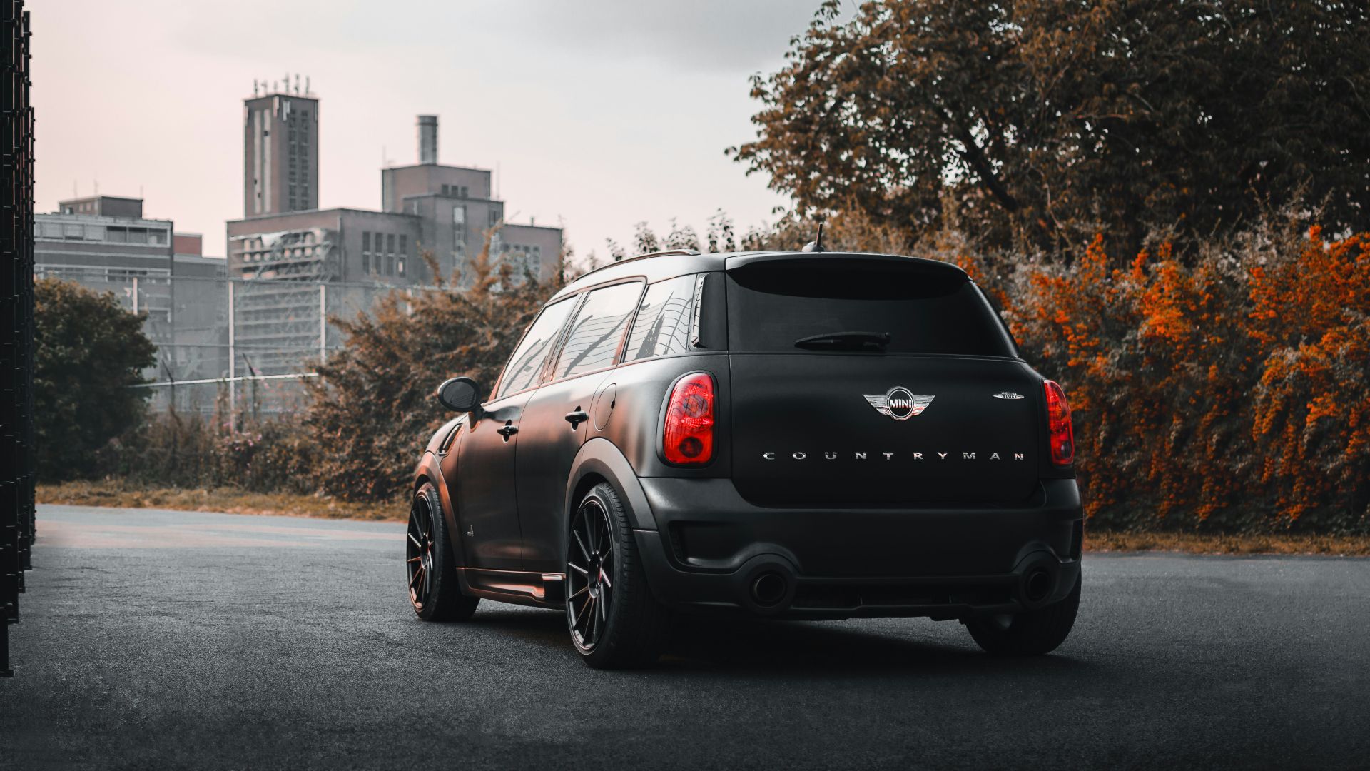 a black minivan parked on the side of the road