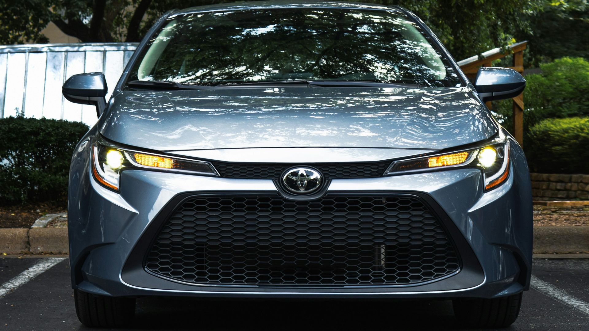 black mercedes benz car parked near green trees during daytime