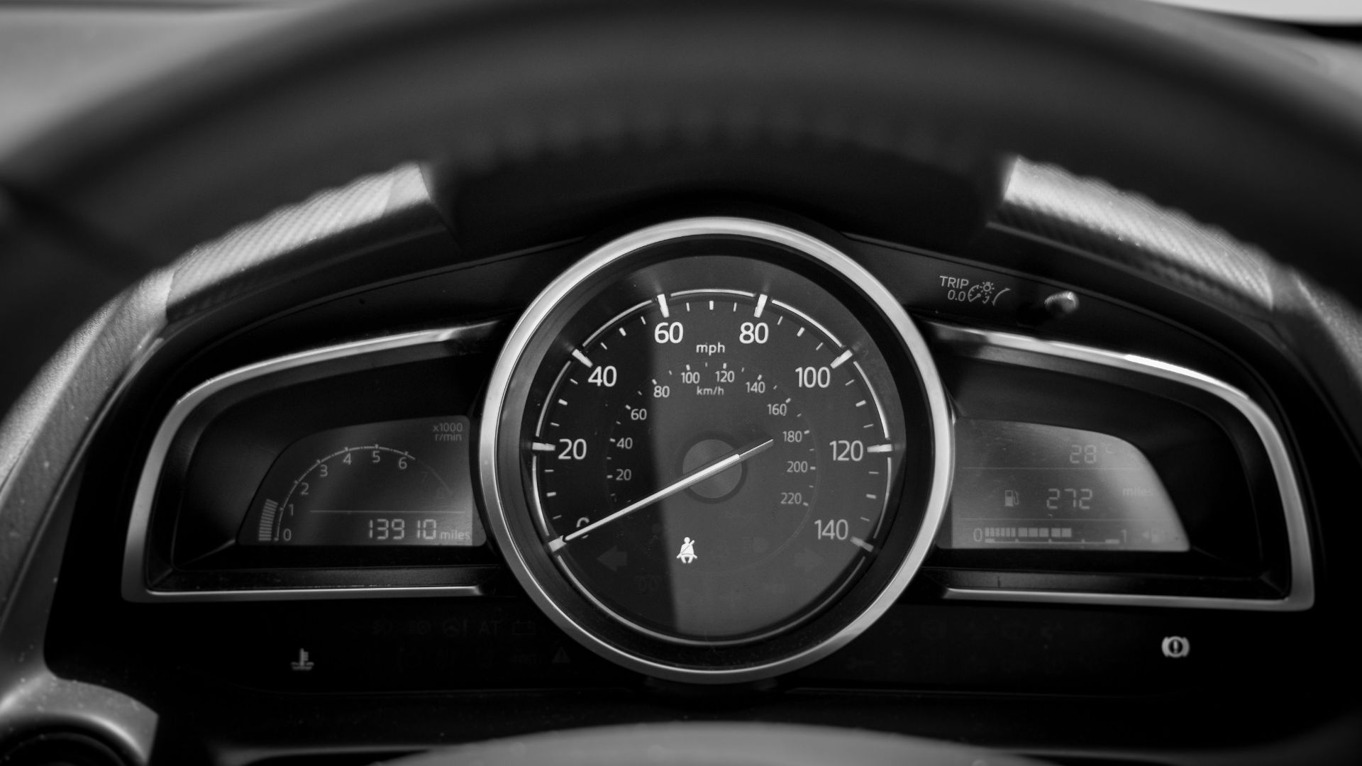black and white car speedometer
