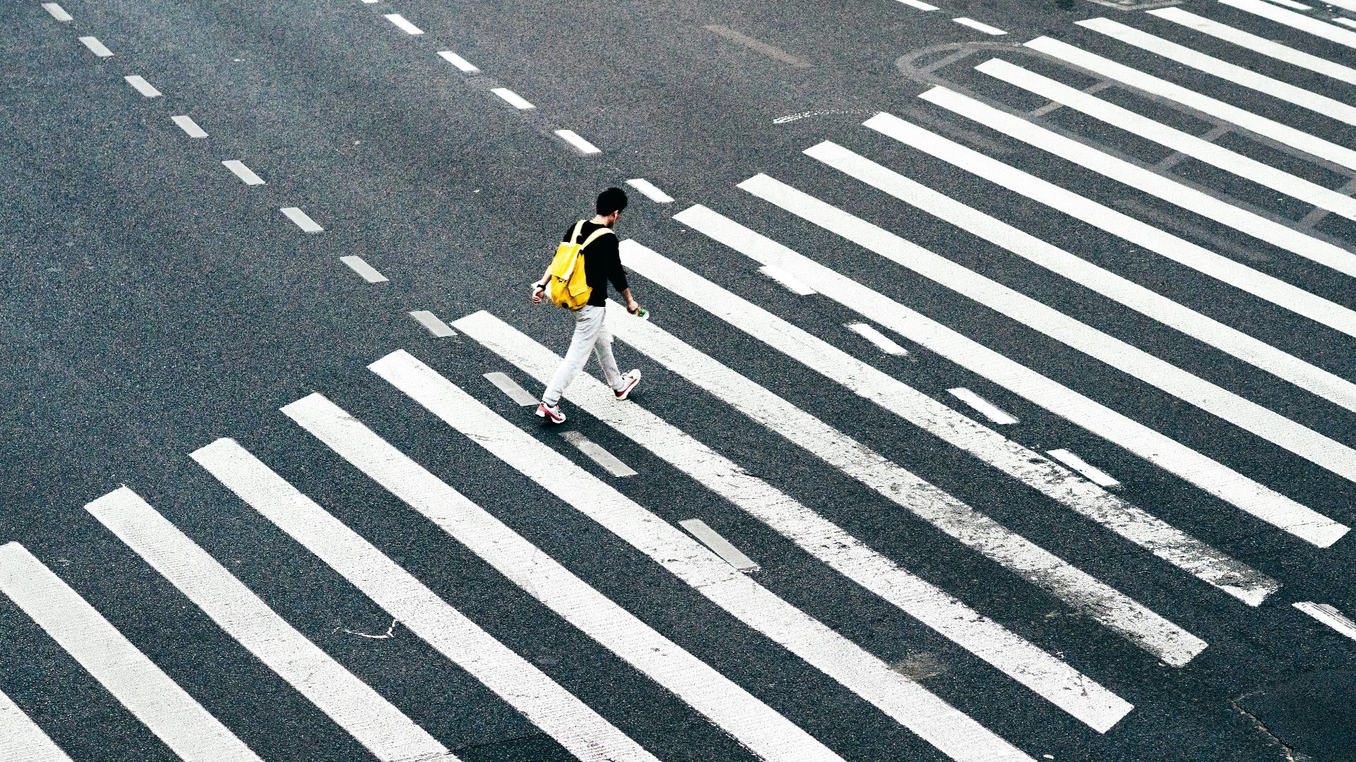 person walking on pedestrian lane during daytime