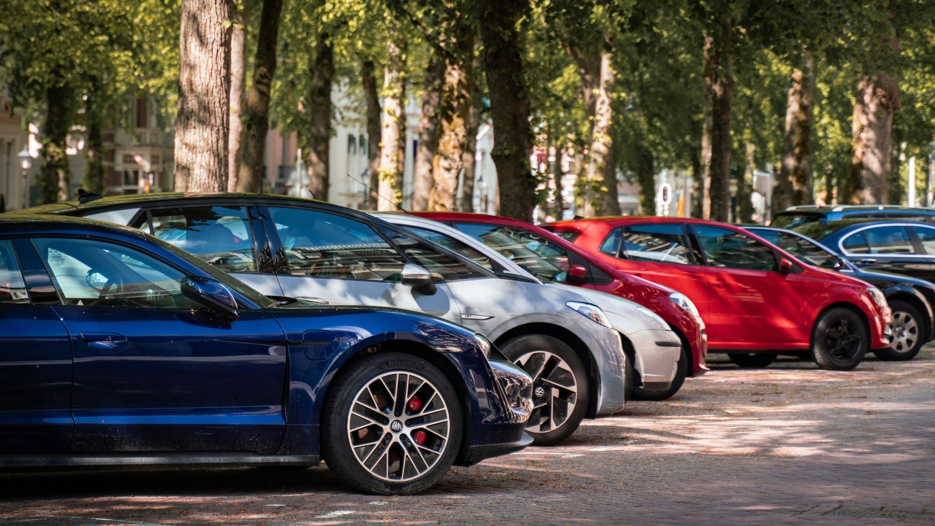 blue and red sports car on road during daytime