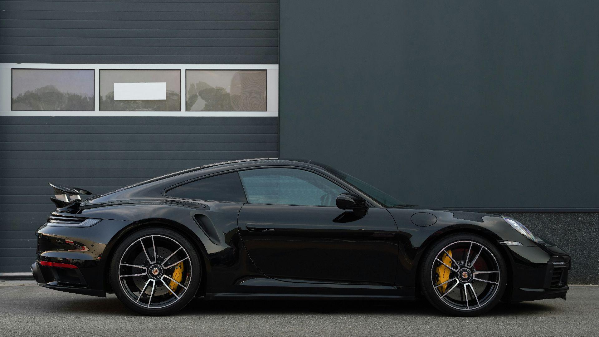 a black sports car parked in front of a building