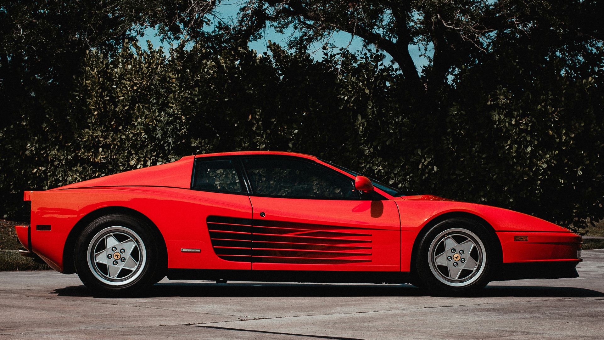 a red sports car parked in a parking lot