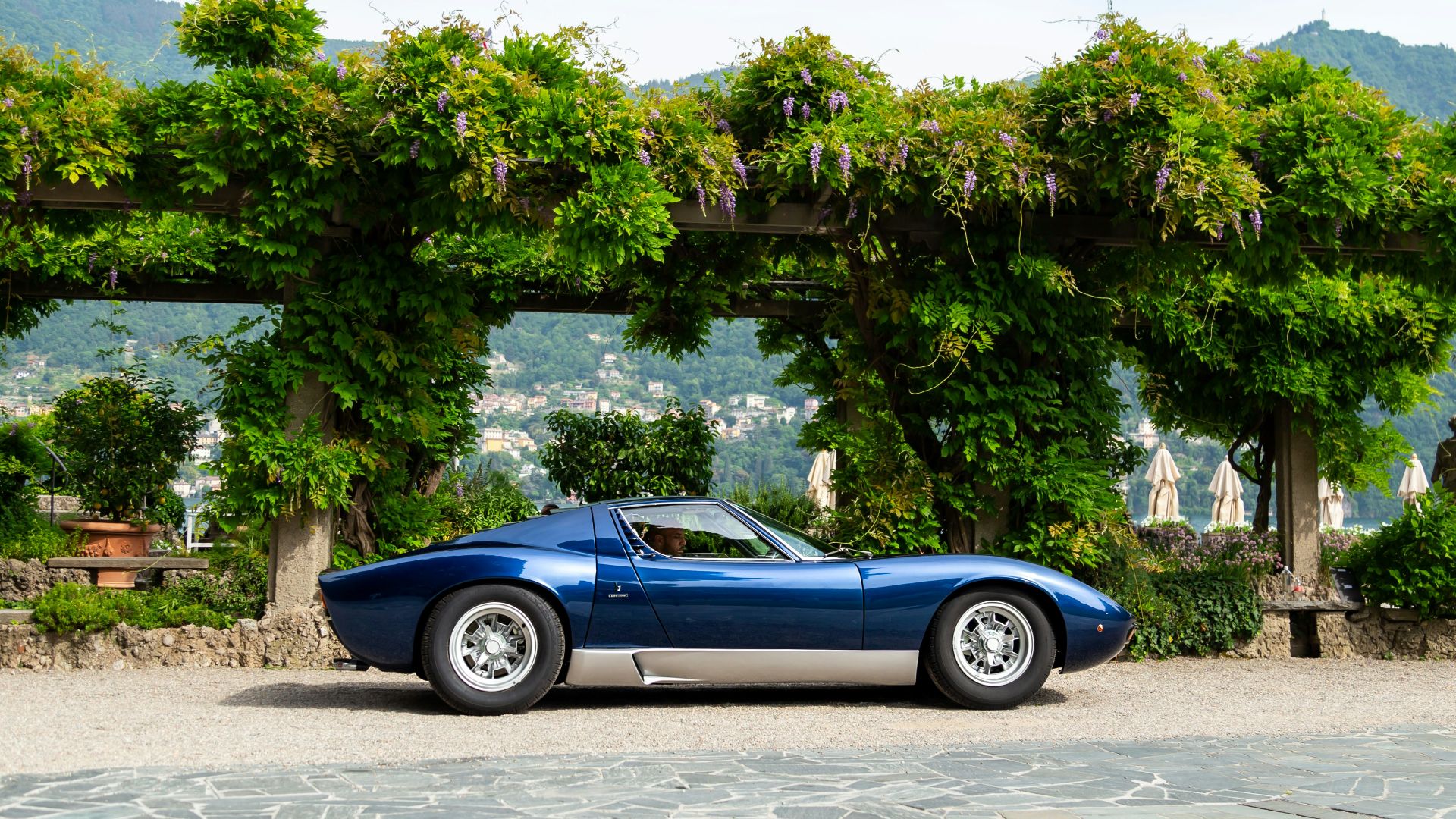 A blue sports car parked in front of a house