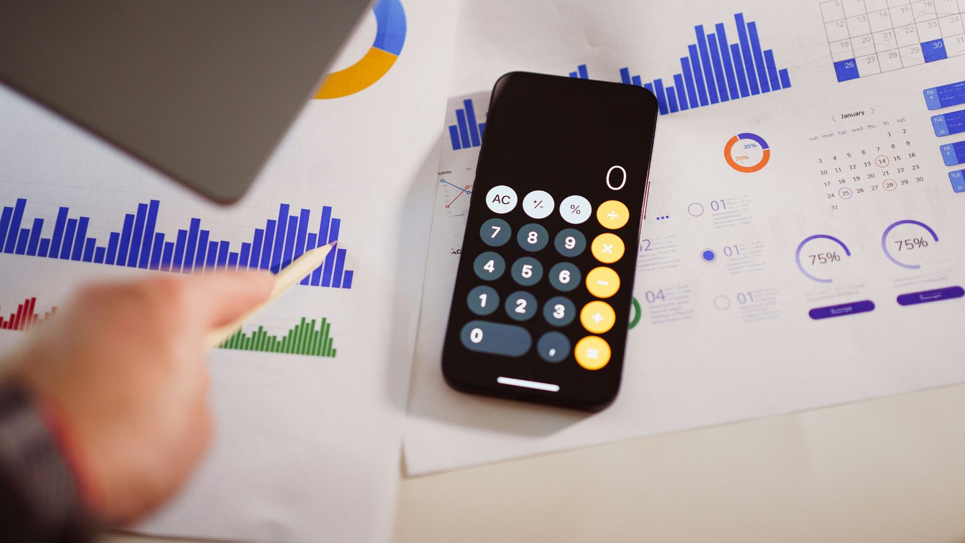 a calculator sitting on top of a table next to a laptop