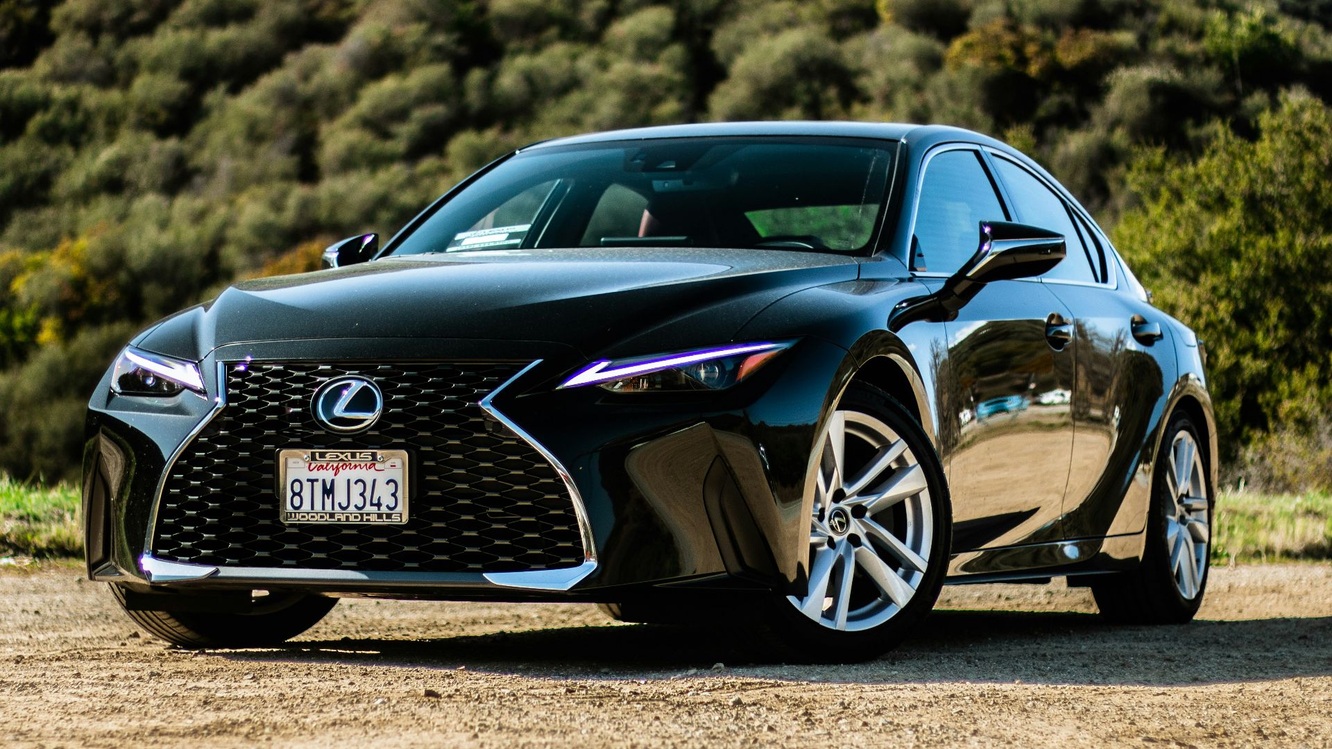 black porsche 911 on brown field during daytime