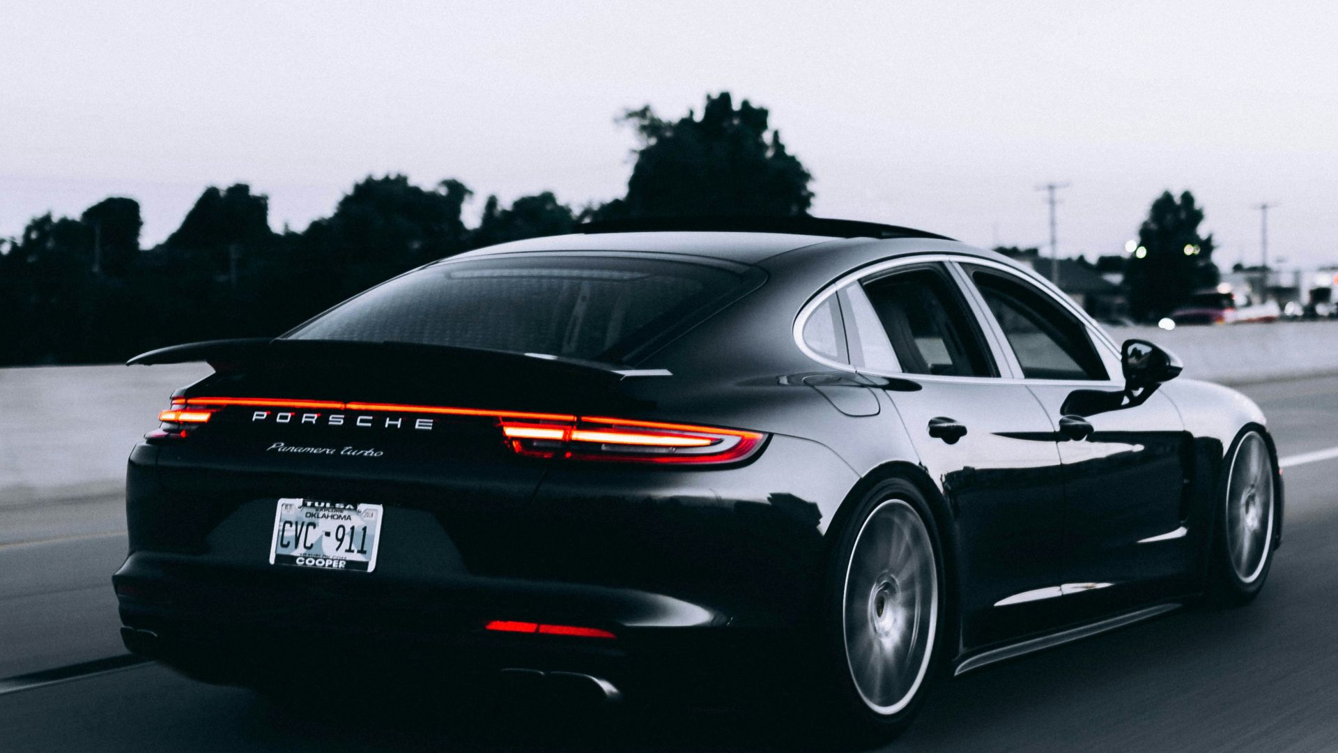 running black Porsche sedan