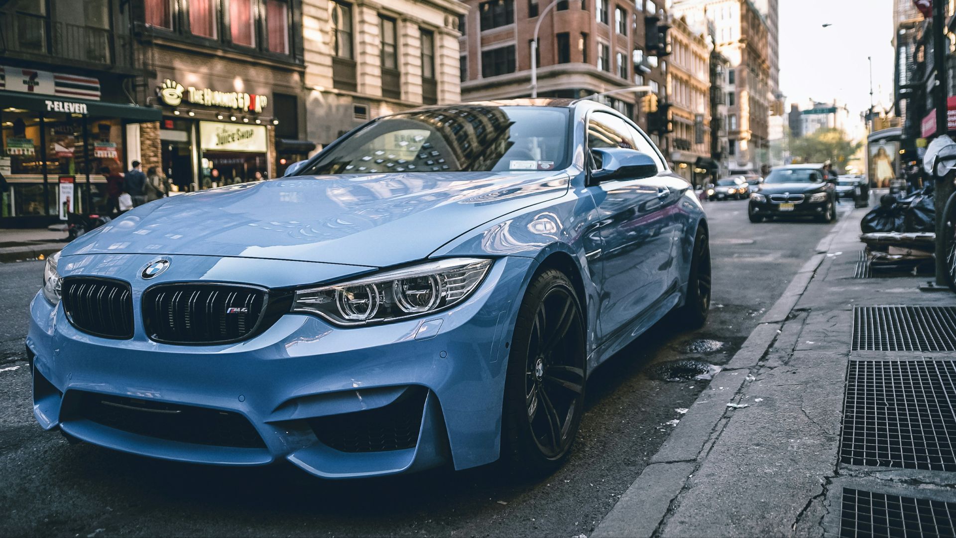 blue BMW coupe parked on the road during daytime