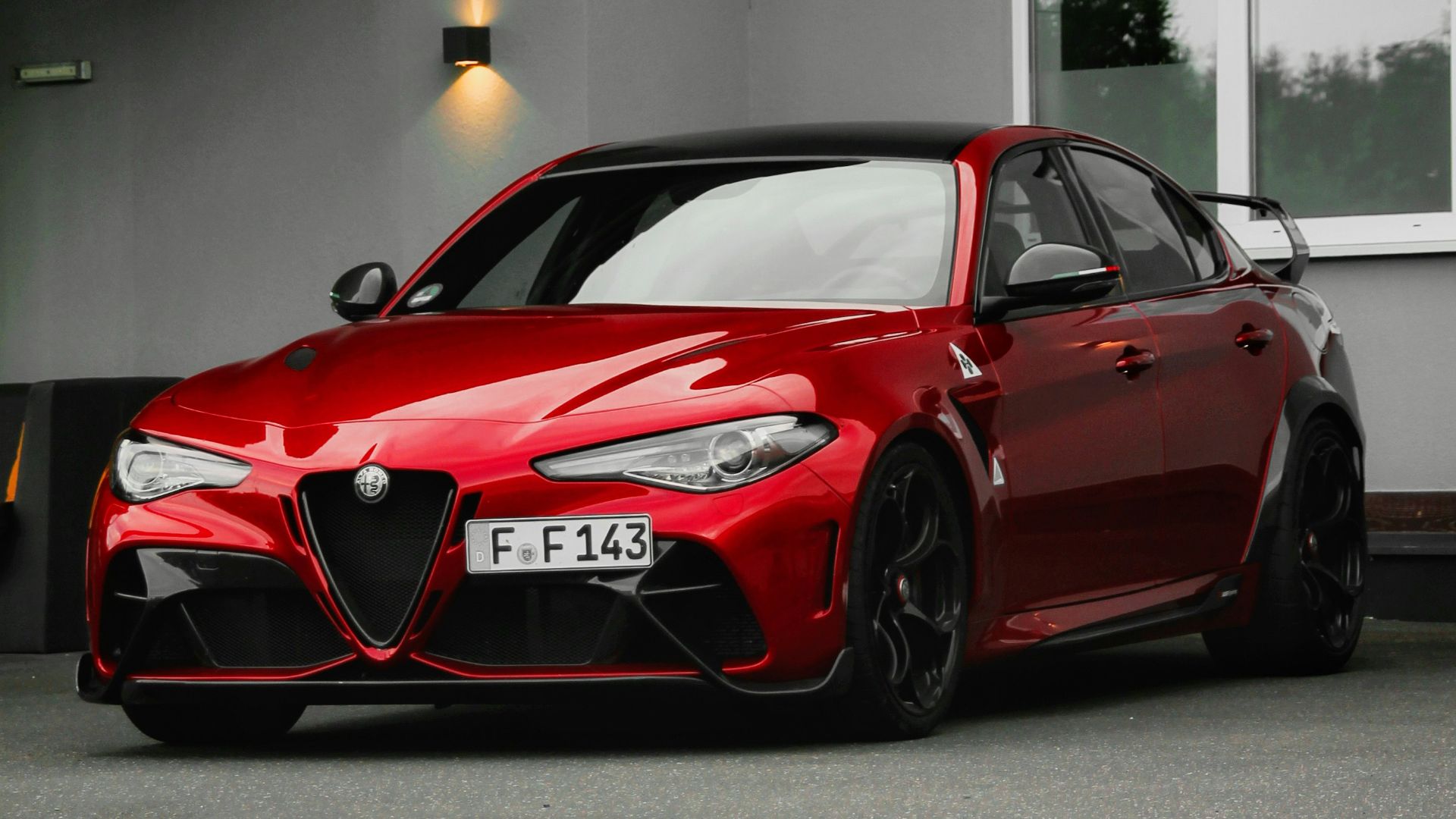 red ferrari 458 italia parked in front of white building