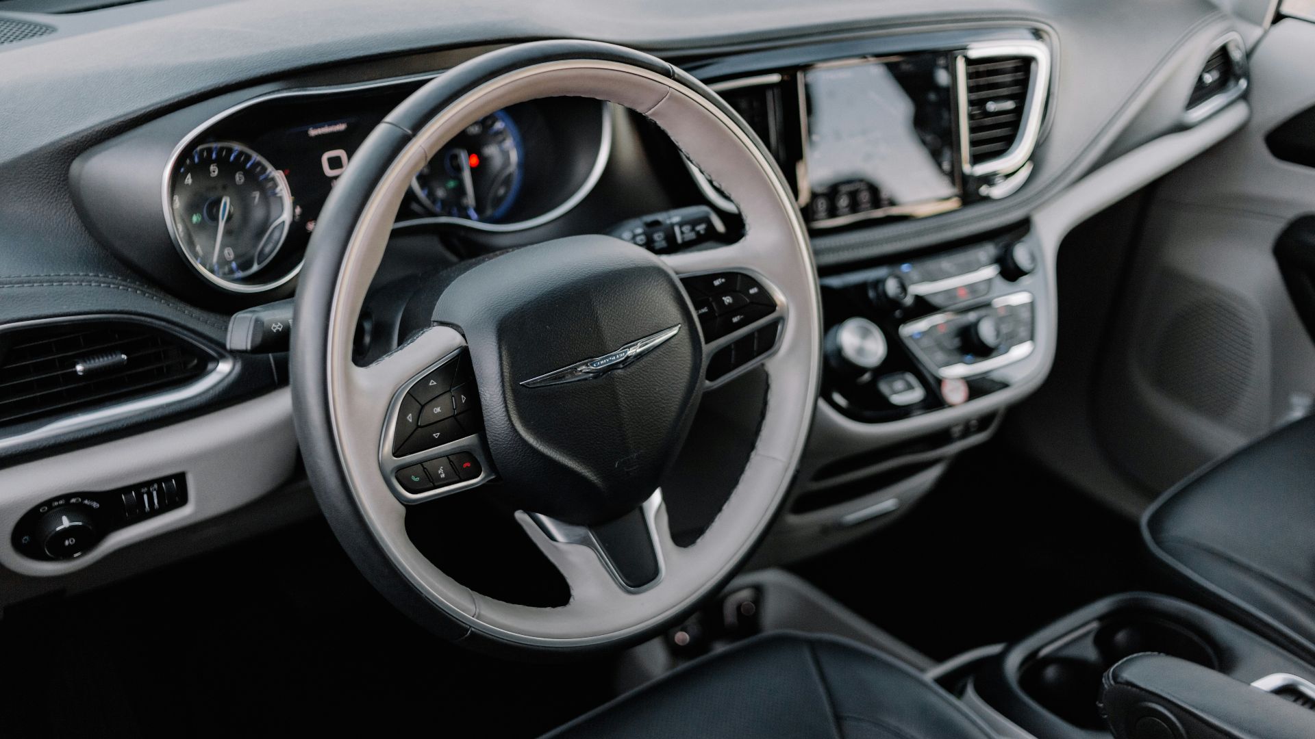 the interior of a car with a steering wheel and dashboard