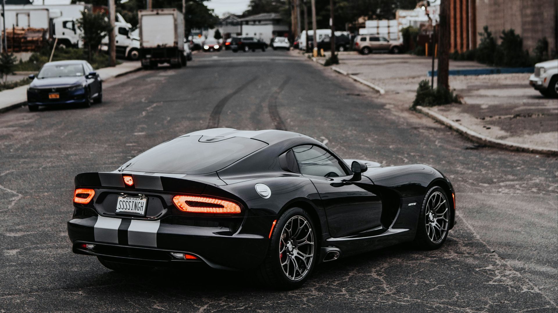 a black sports car parked in a parking lot
