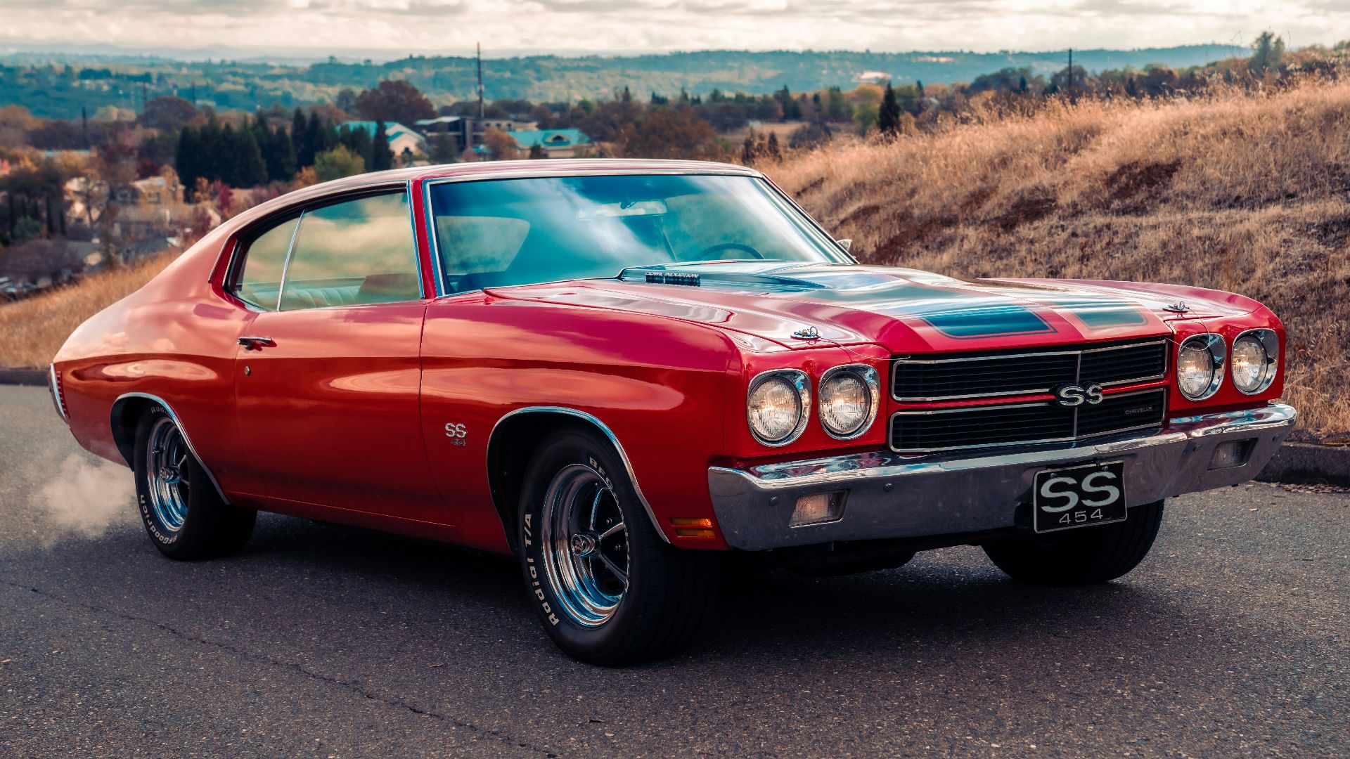 red chevrolet camaro on road during daytime